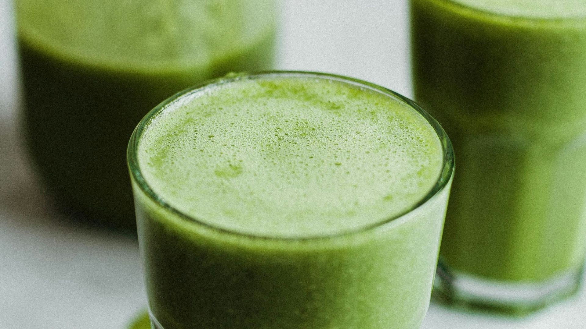 green liquid in clear drinking glass