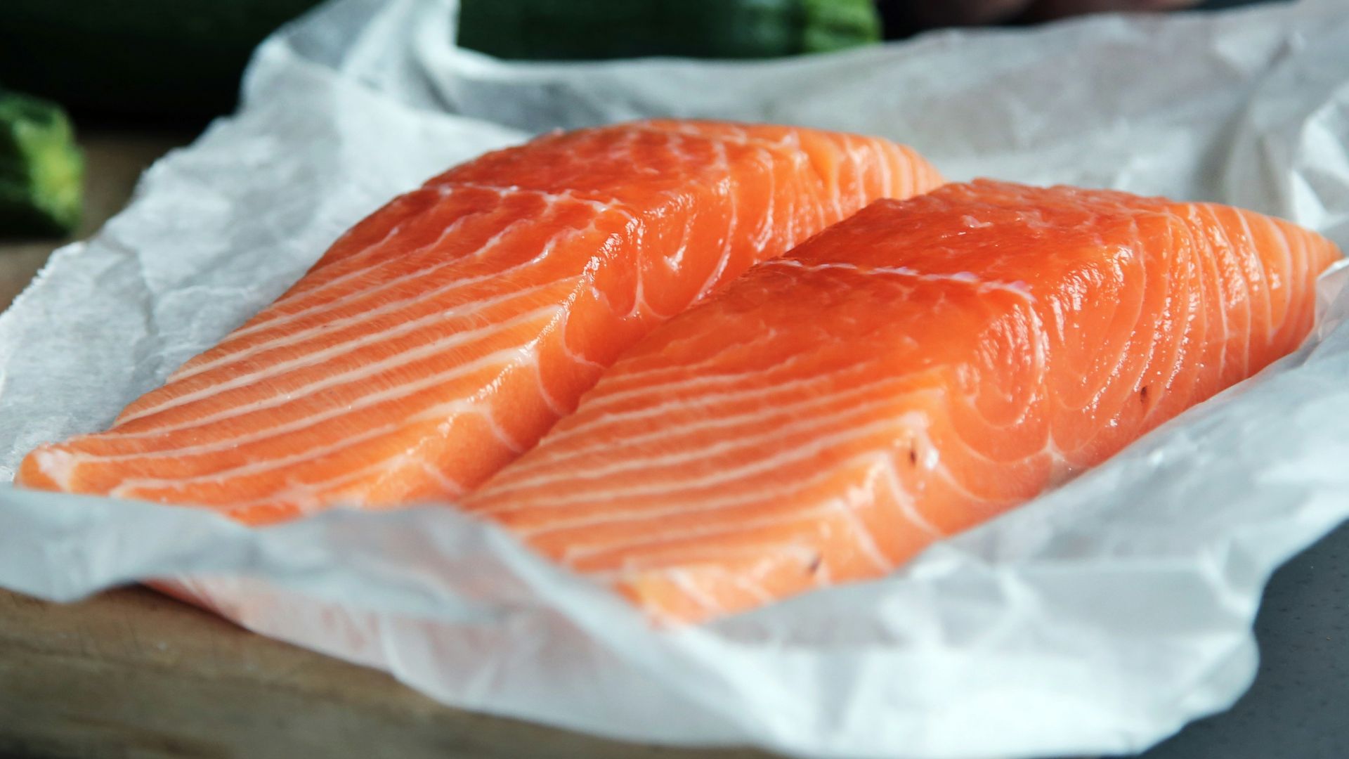 raw fish meat on brown chopping board