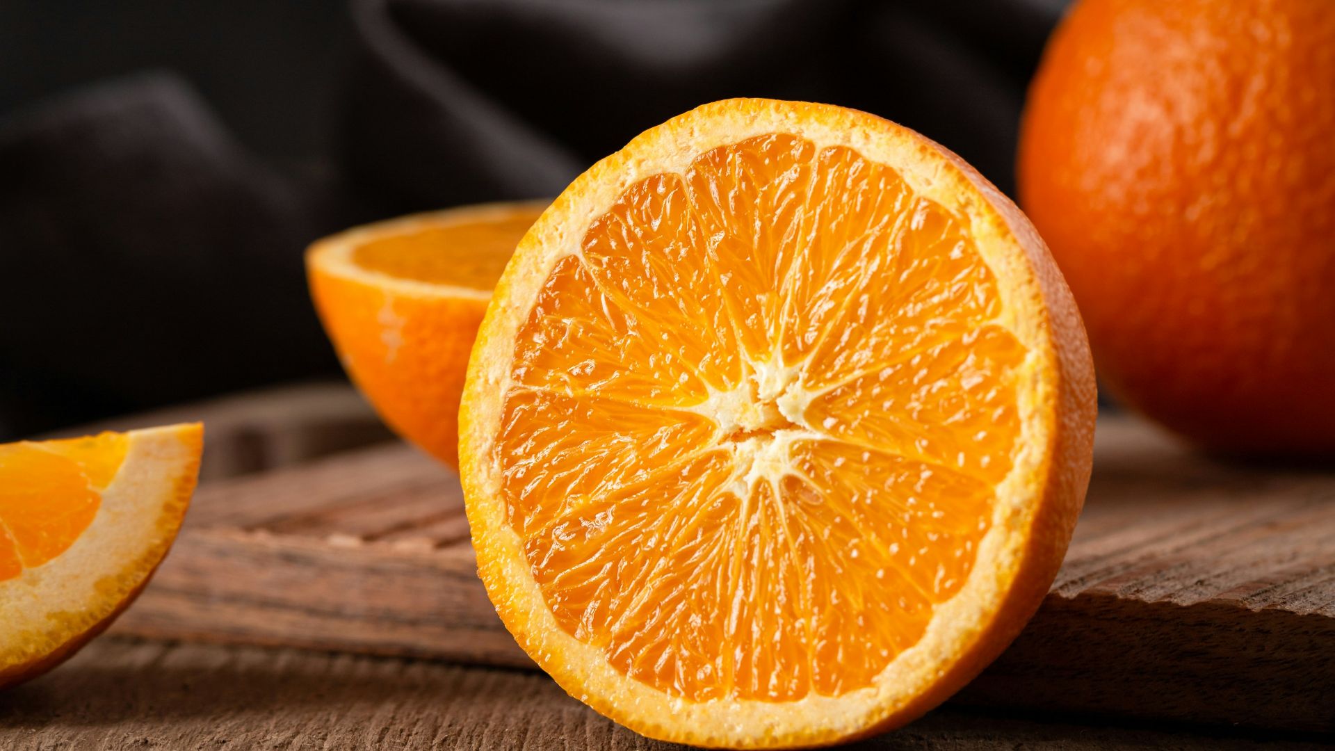 sliced orange fruit on brown wooden table