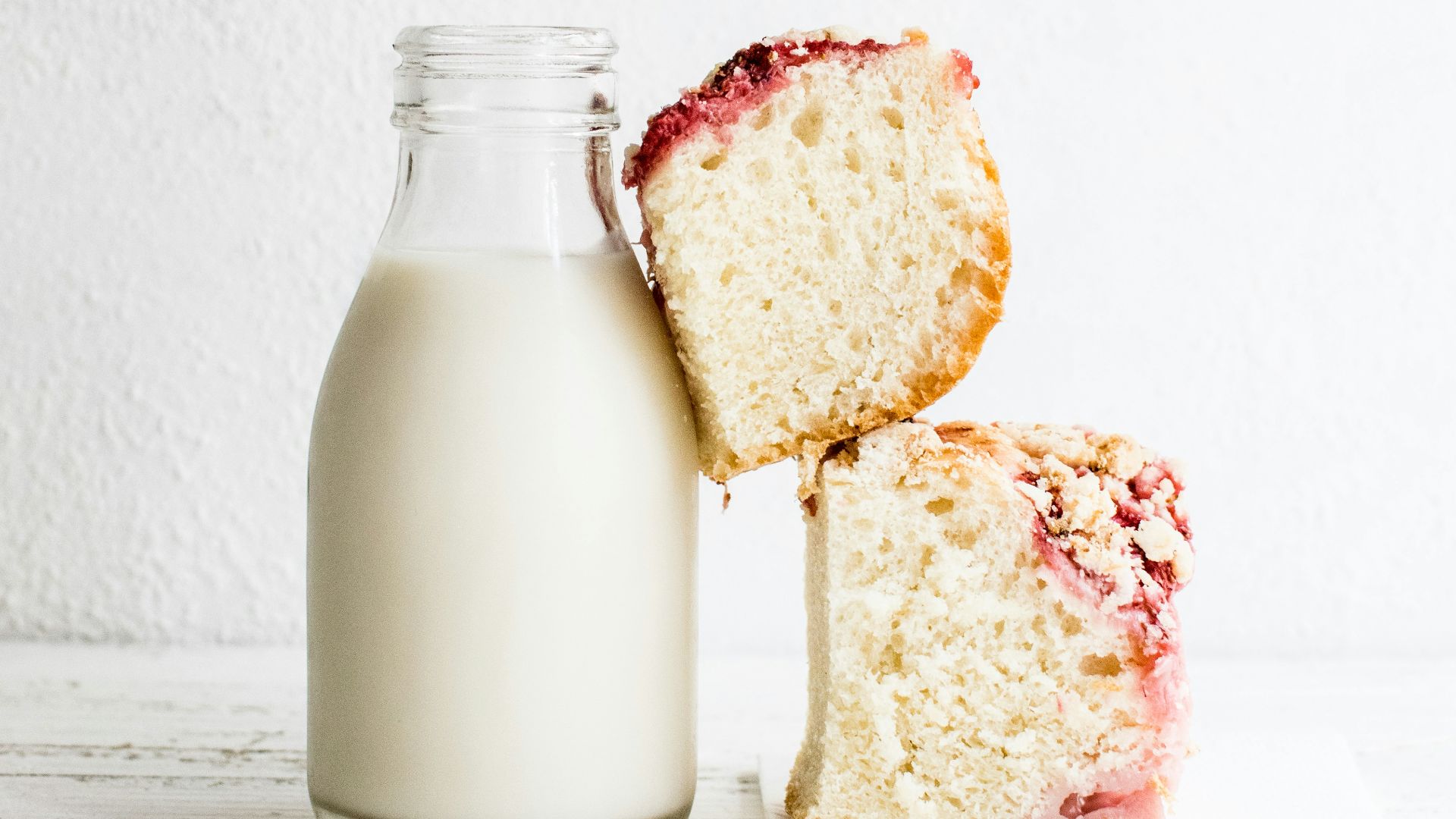 baked bread and black glass of milk
