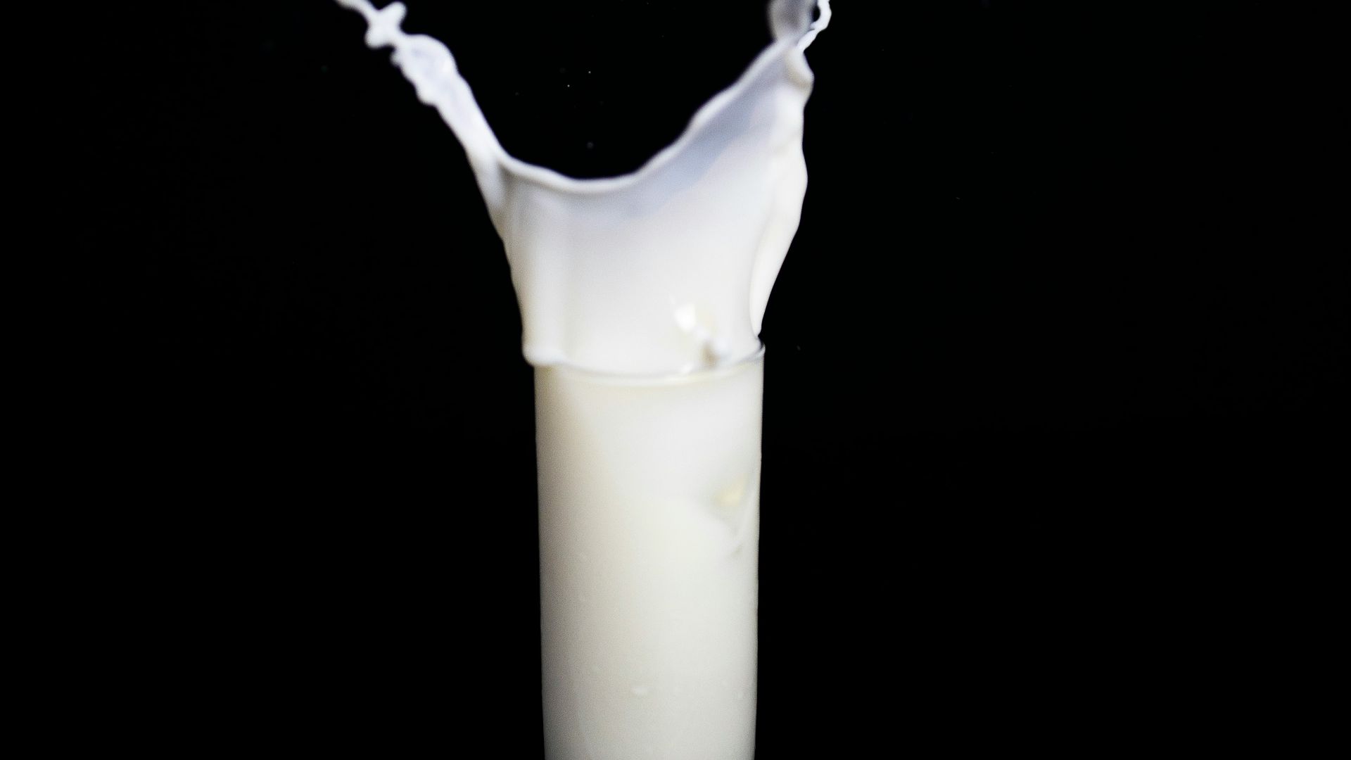 white candle in black holder