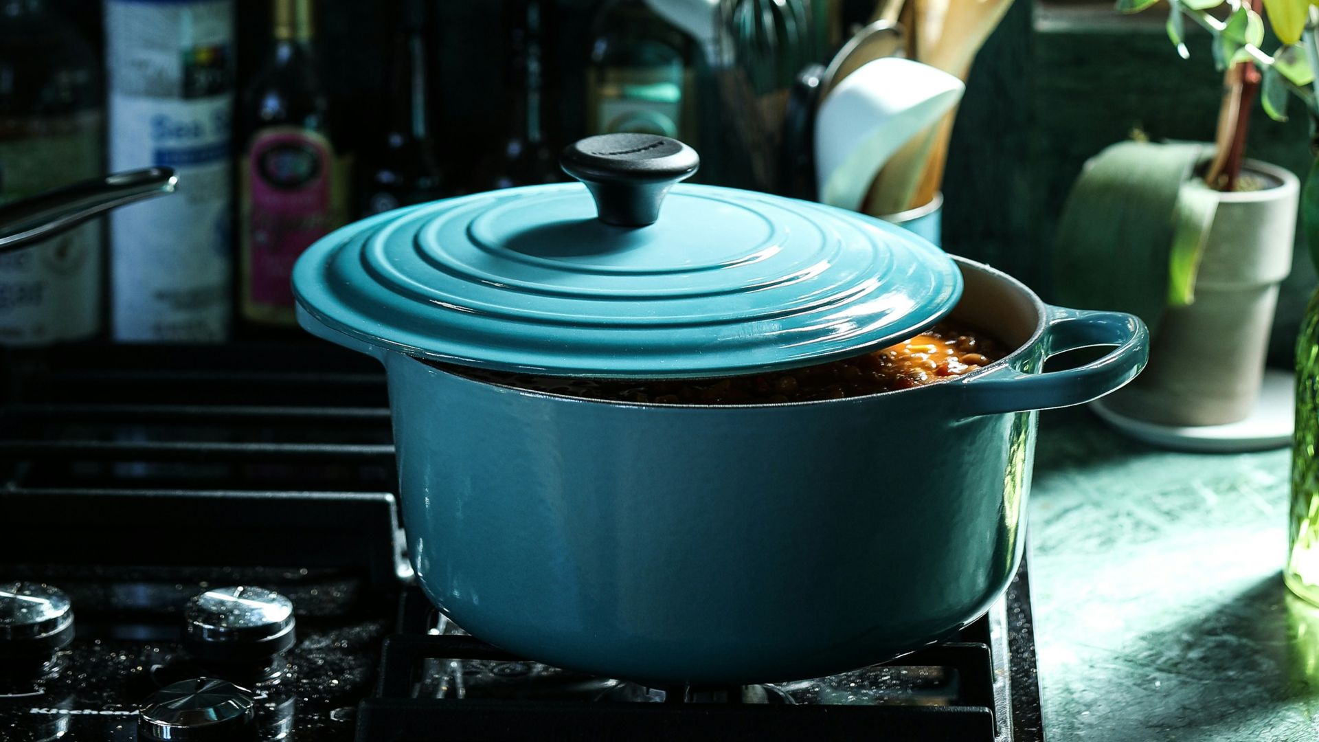 partly opened blue metal pot on stove