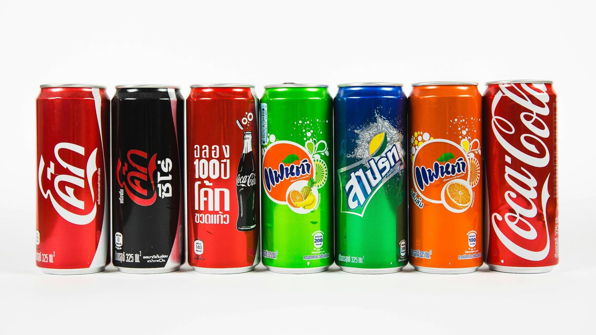 seven assorted-brand soda cans