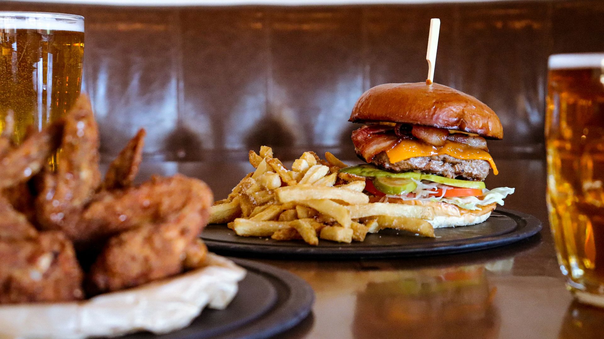 burger with fries on black ceramic plate