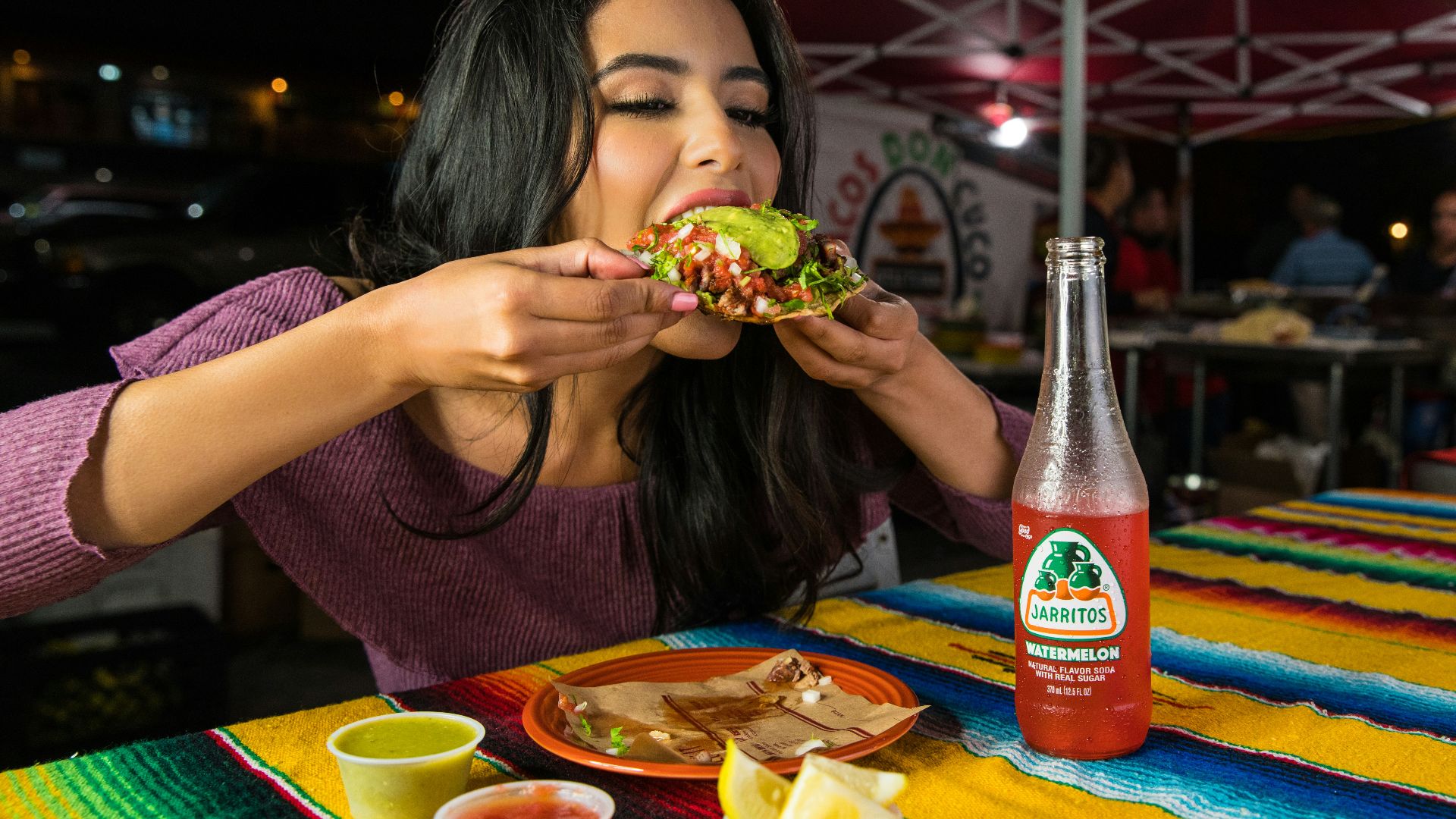 woman in purple shirt holding green and yellow floral ceramic bowl
