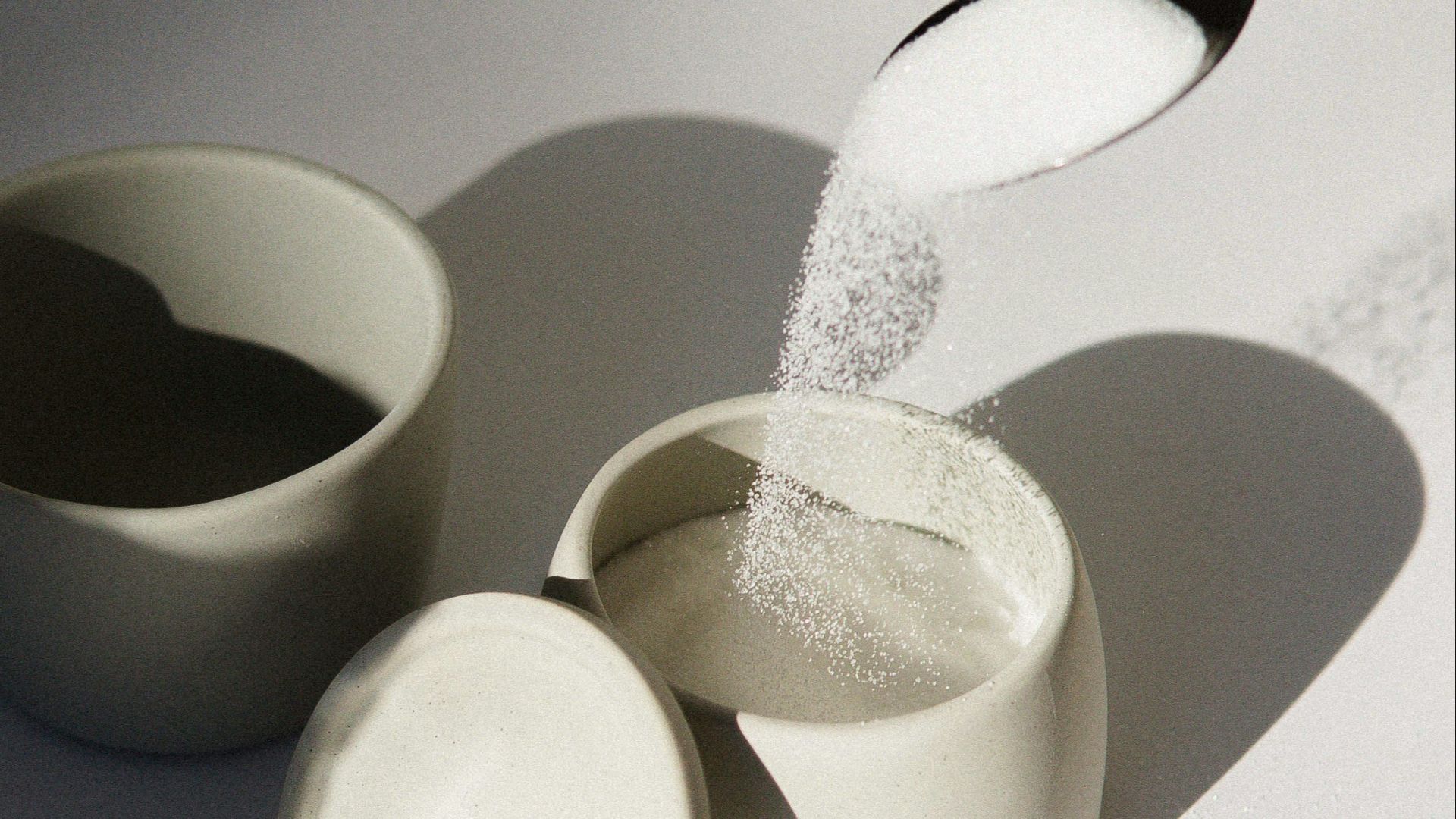white ceramic mugs on white table