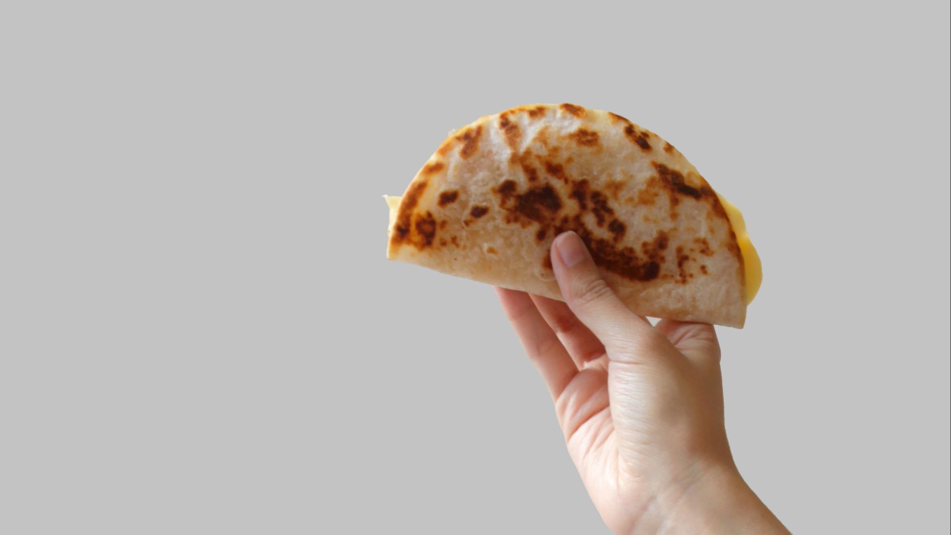 person holding pancake raising it up