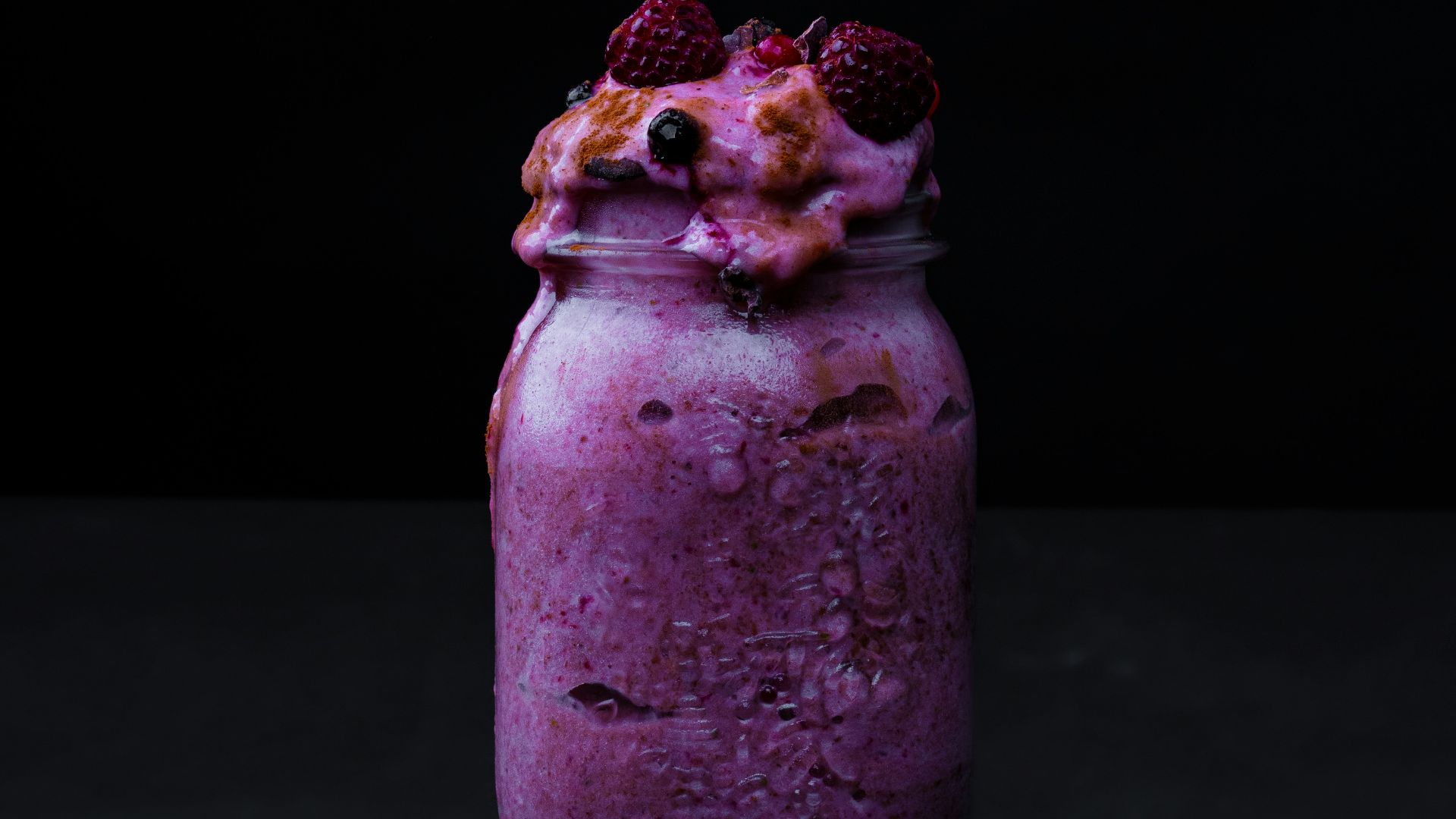 clear glass jar with red and green fruits