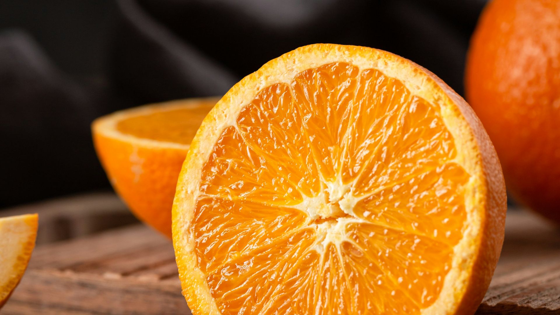 sliced orange fruit on brown wooden table