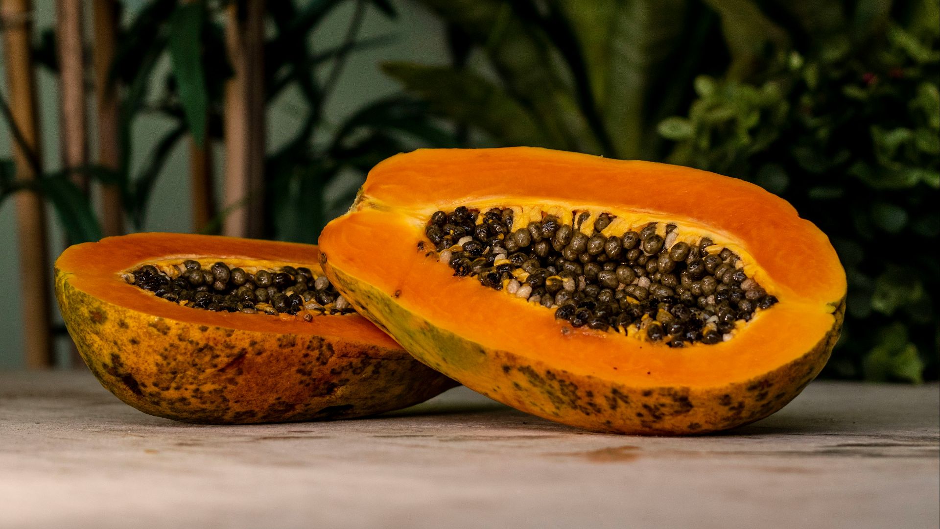 sliced papaya fruits on brown surface