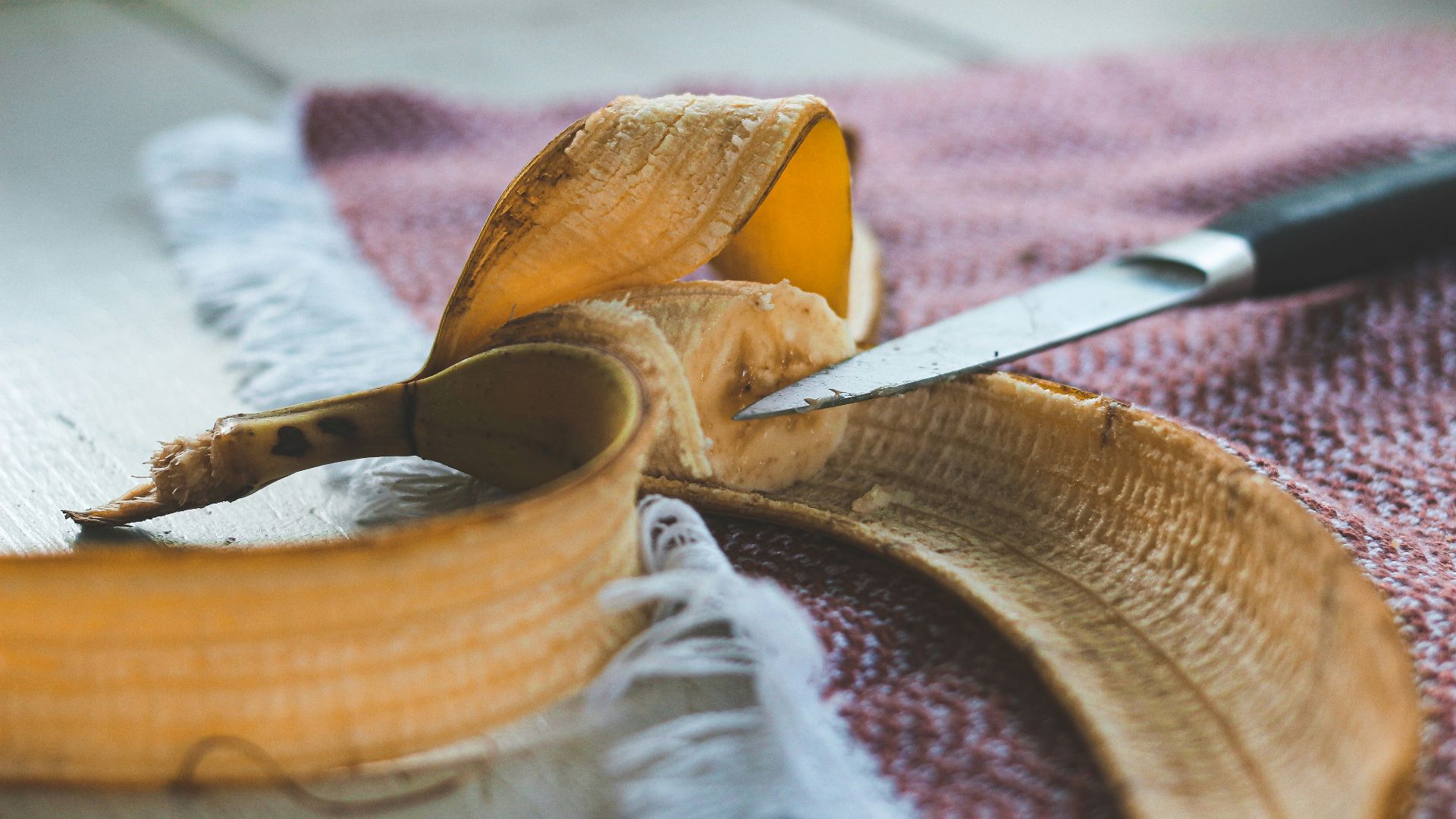 sliced yellow fruit on brown wooden chopping board