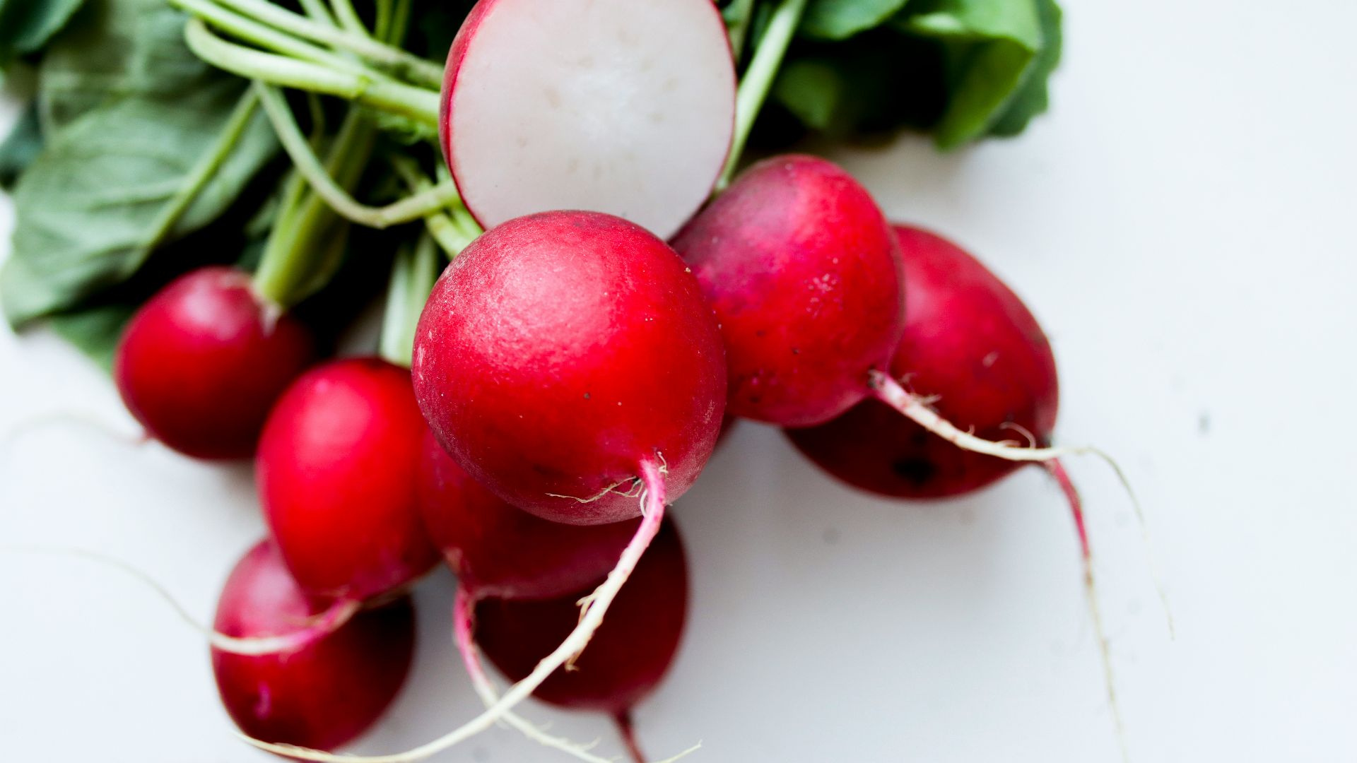 red tomato on white surface