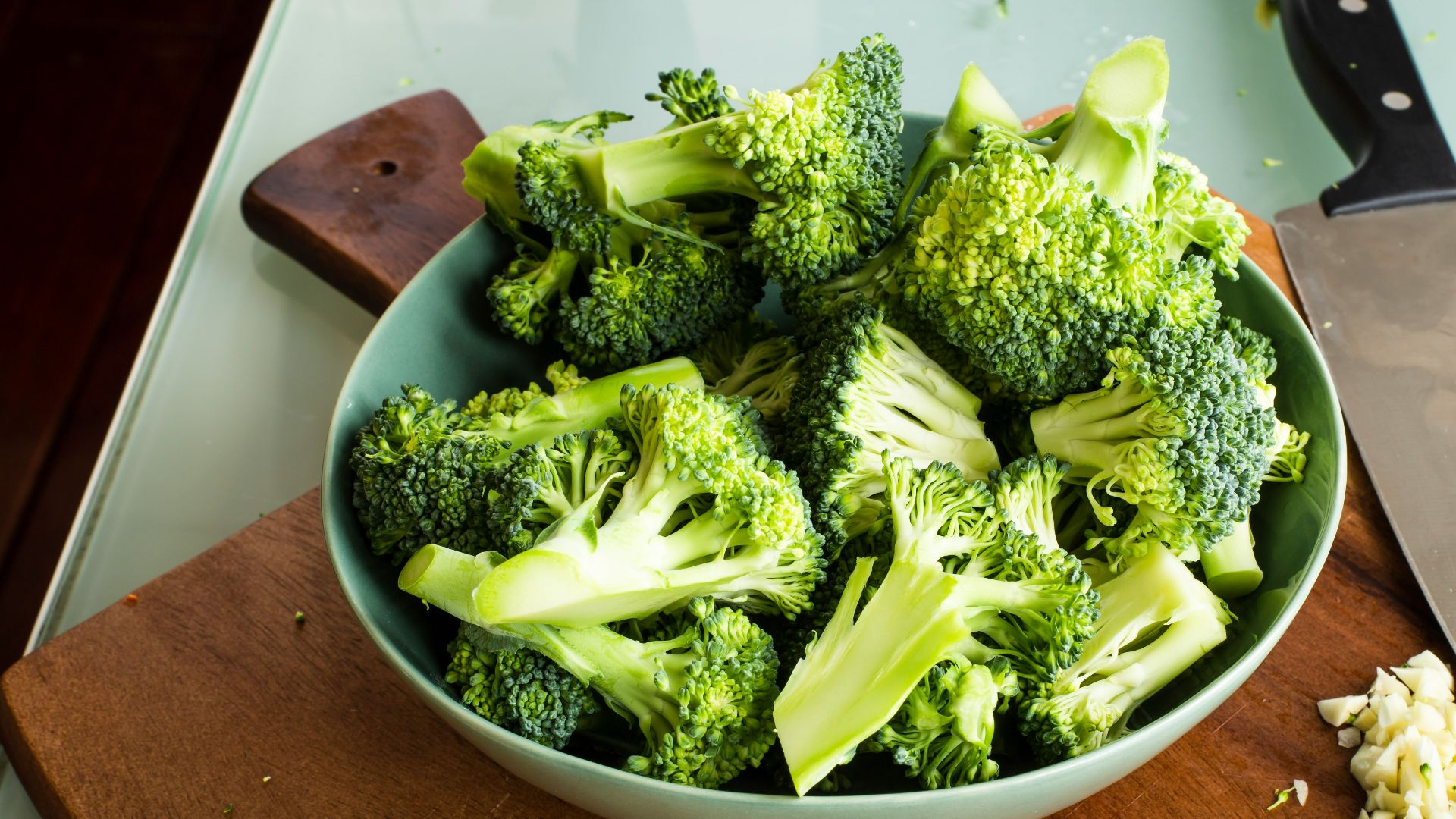 green broccoli on brown wooden chopping board
