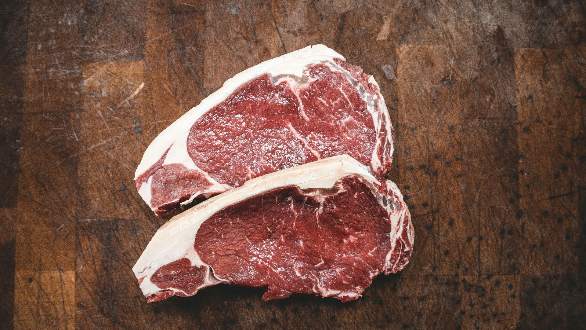 raw meat on brown wooden table