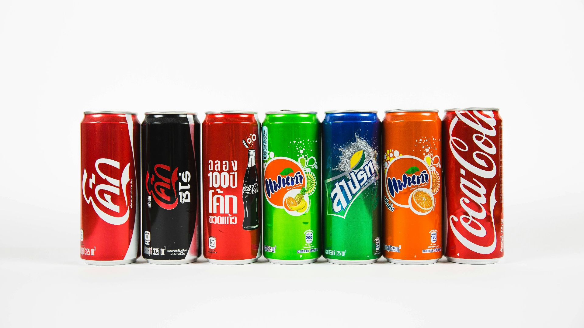 seven assorted-brand soda cans