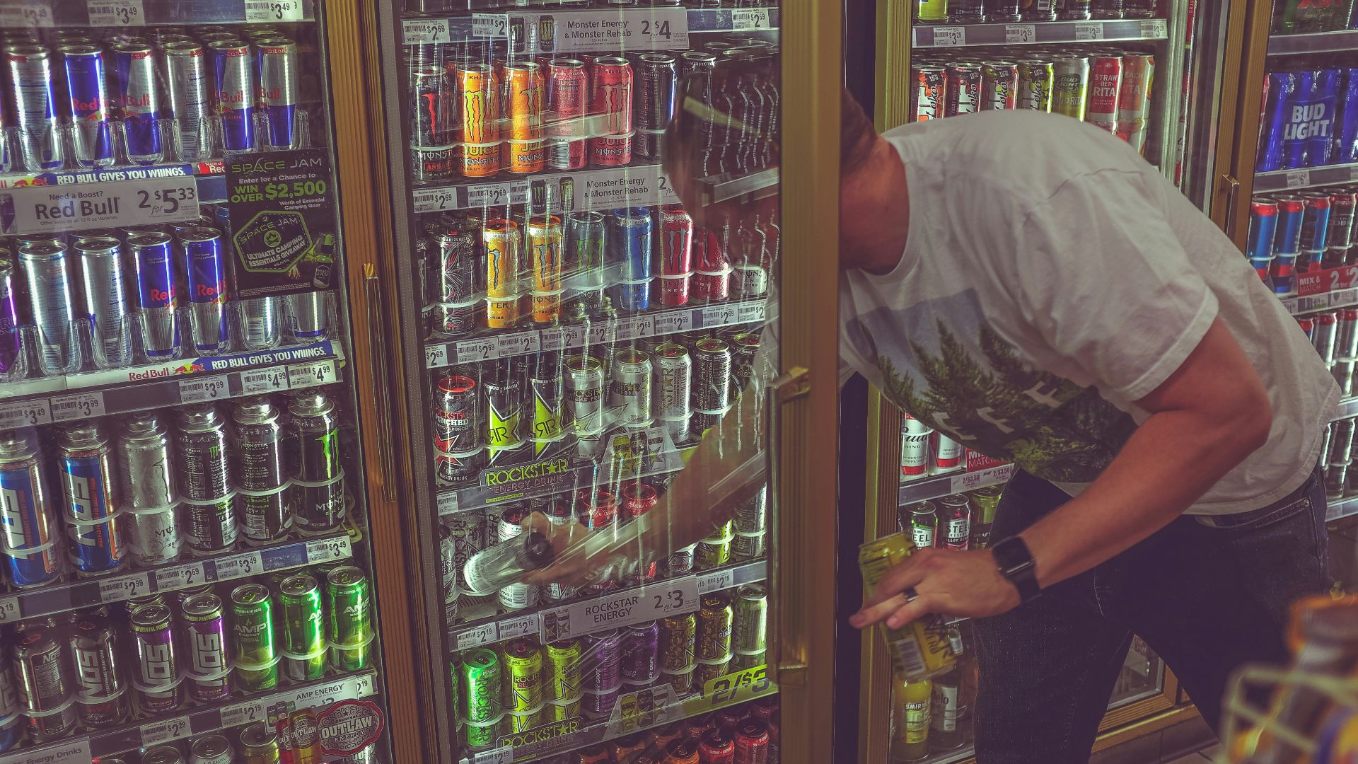 man getting can in beverage cooler
