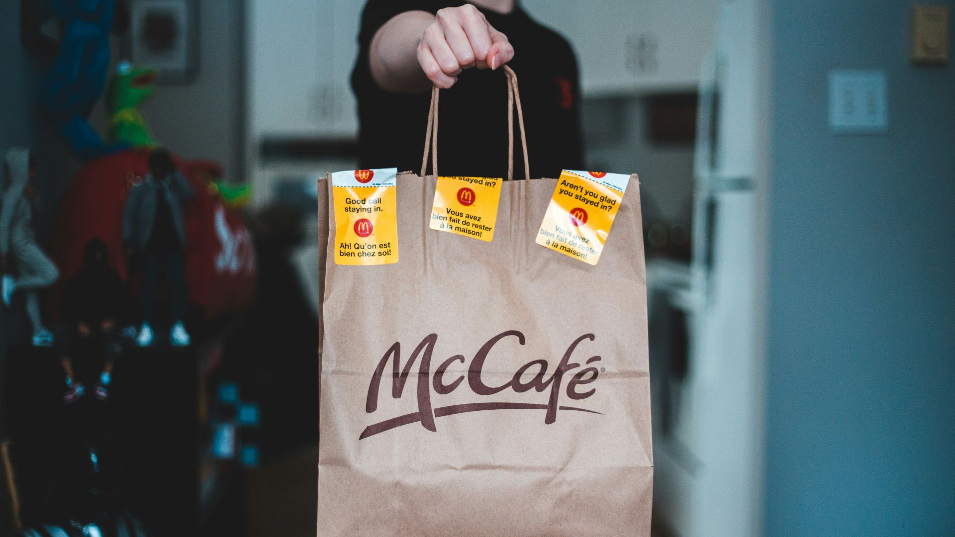 person holding white and brown paper bag