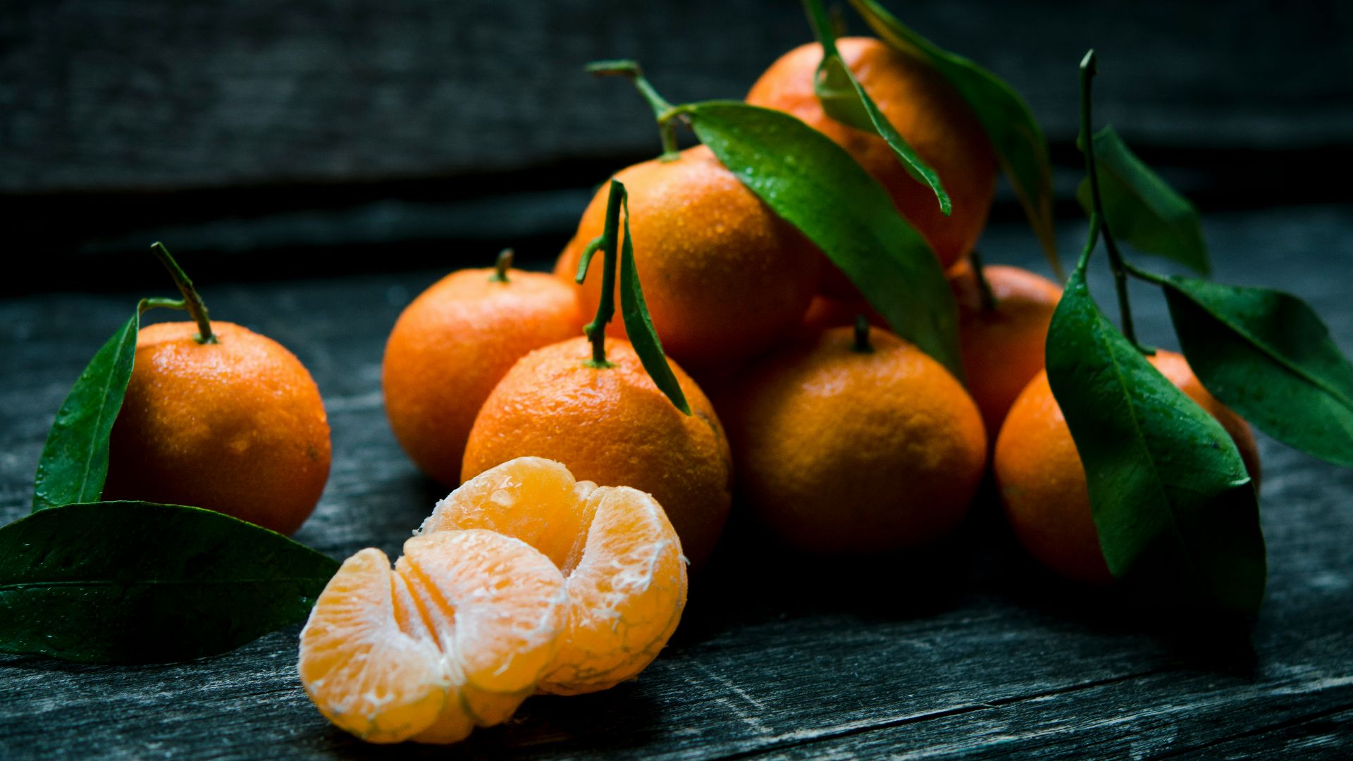 oranges on top of gray wooden table
