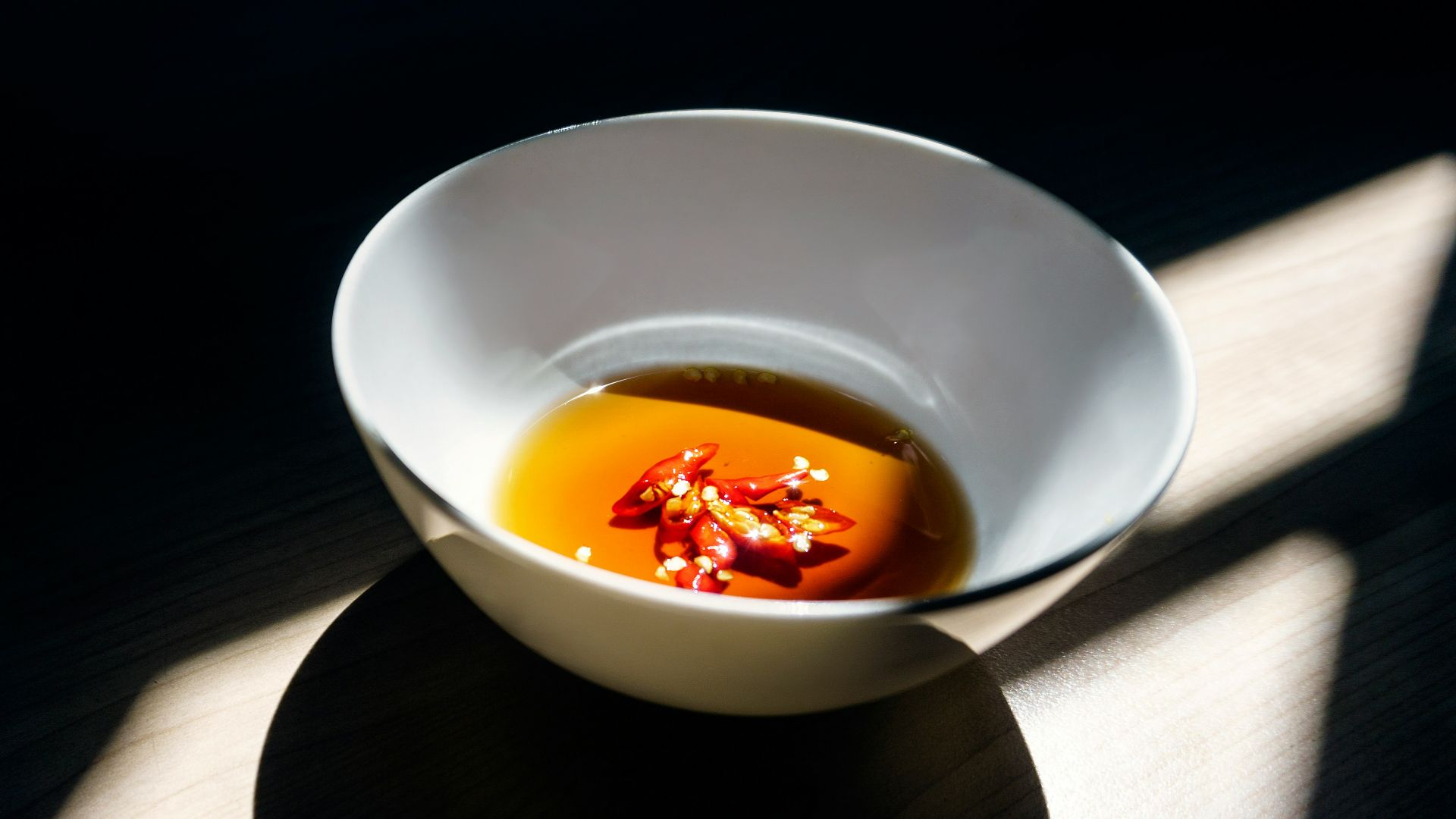 white ceramic bowl on wooden surface