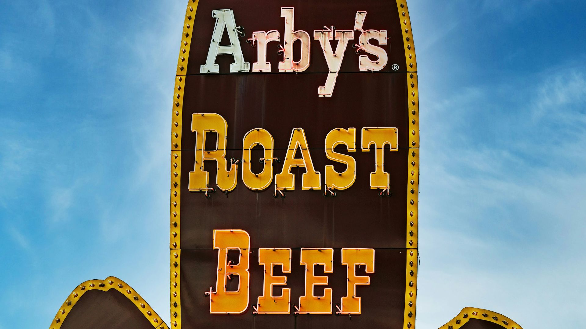 A sign for a restaurant called andy's roast beef sandwich
