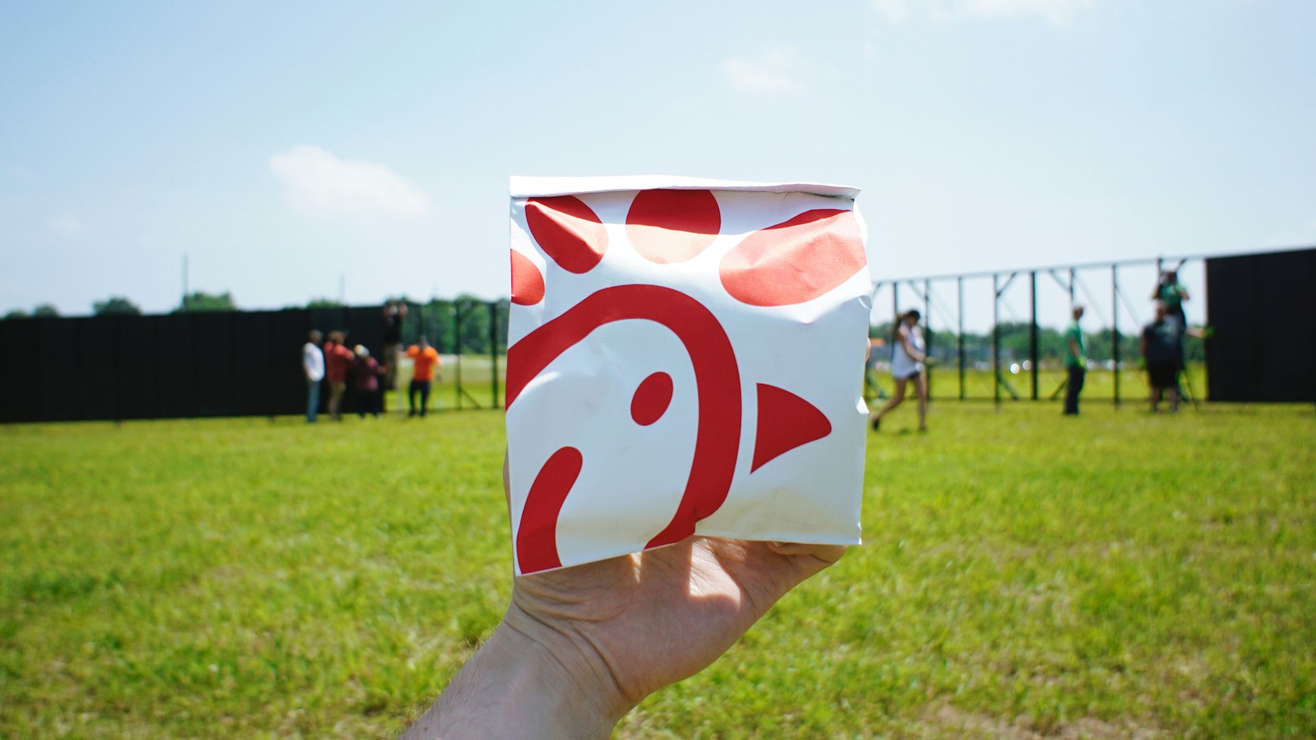 person holding white and red box