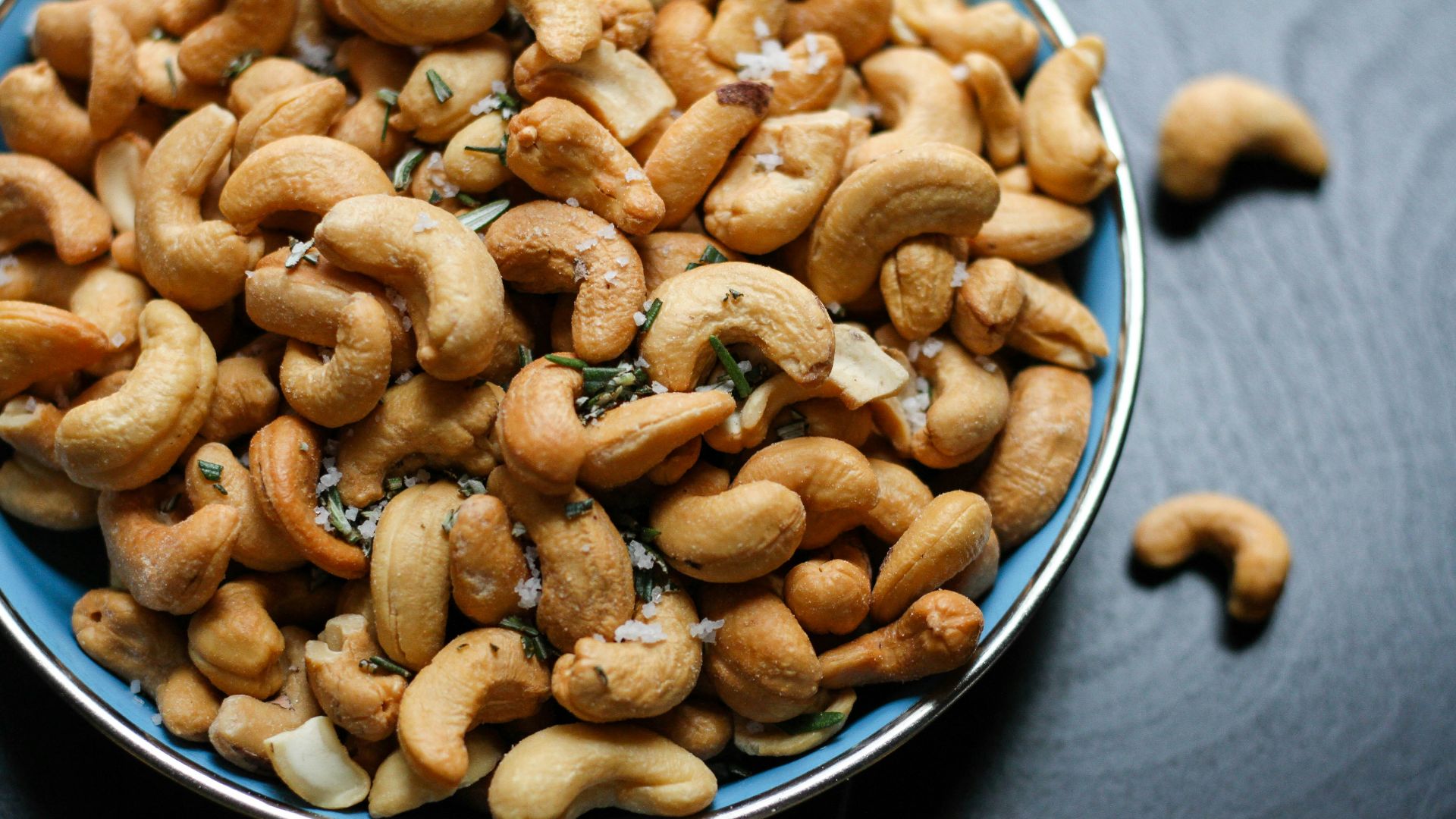 cashew nut lot on blue ceramic bowl