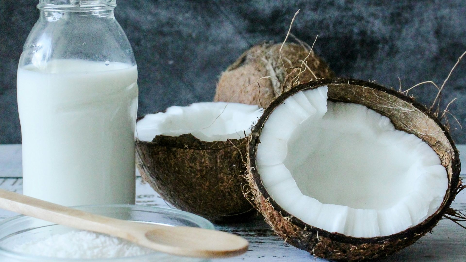 white pillar candle on brown wooden coaster
