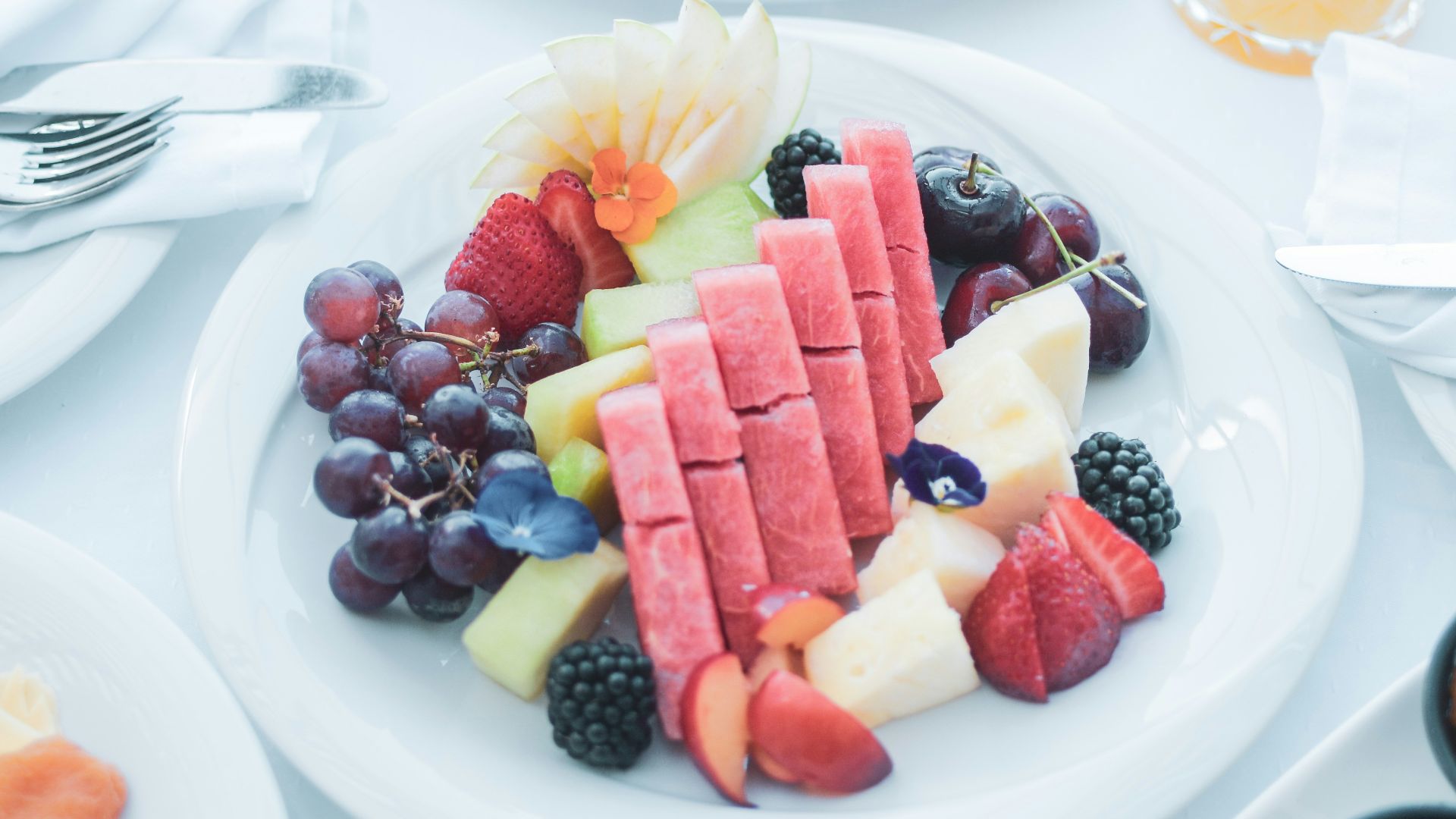 a white table topped with plates of food