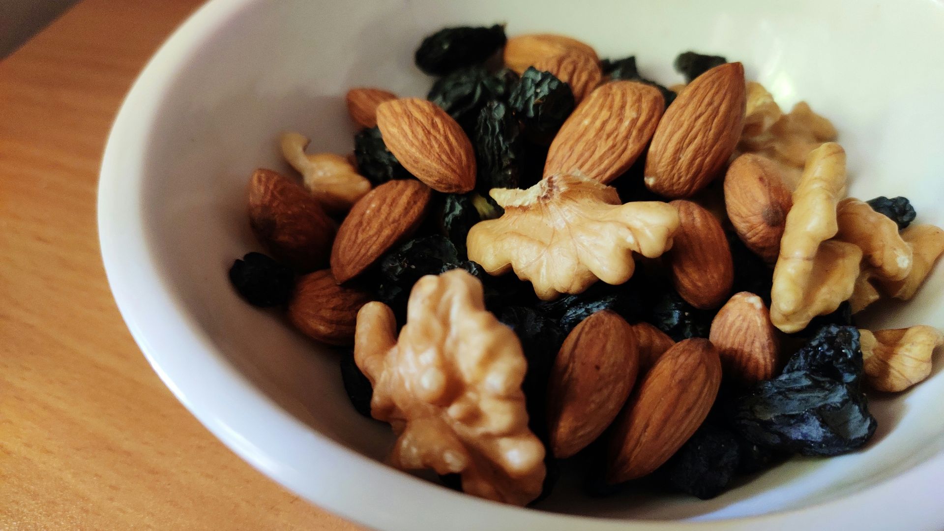 brown and black nuts on white ceramic bowl