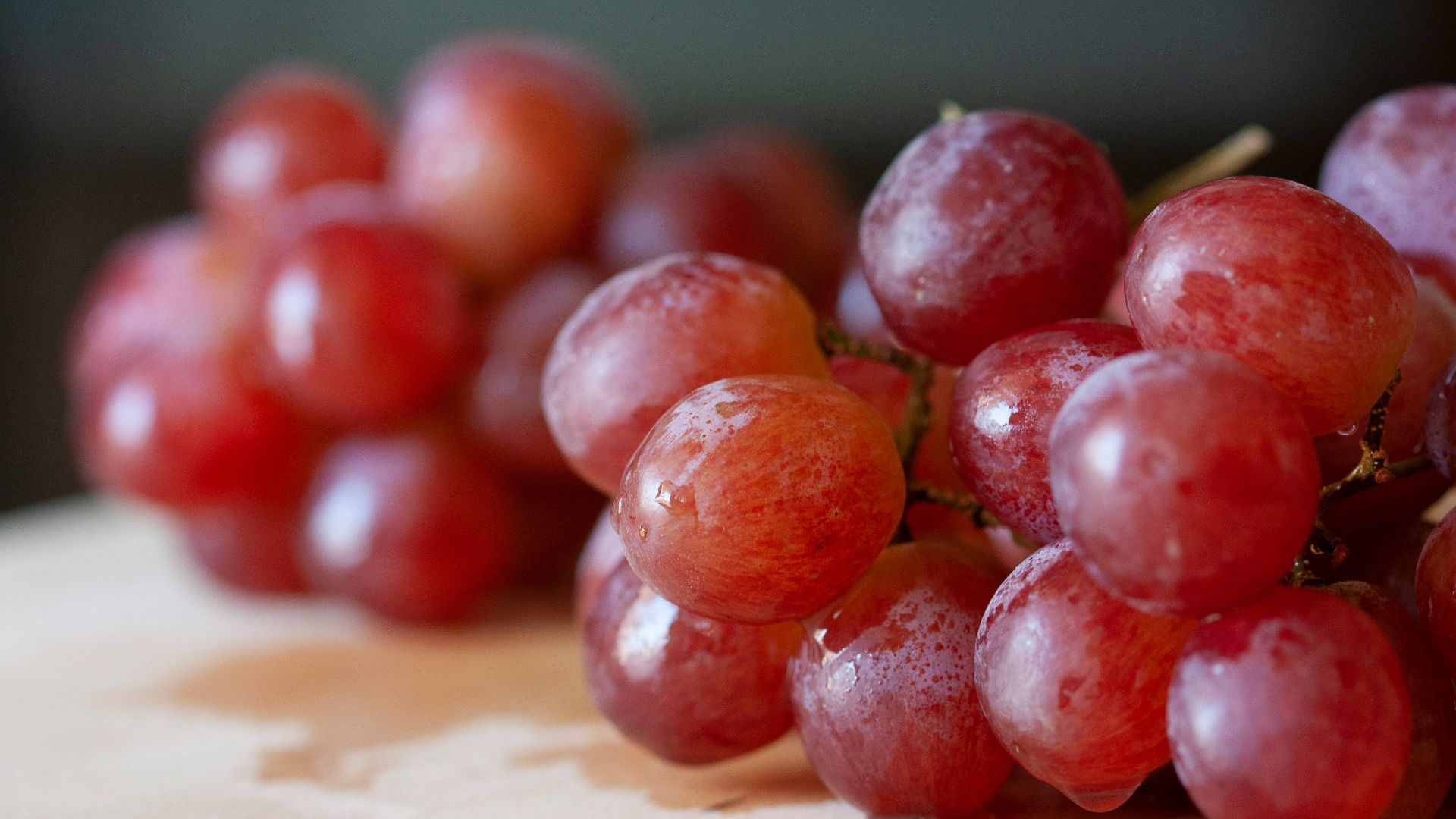 red round fruits on brown wooden table