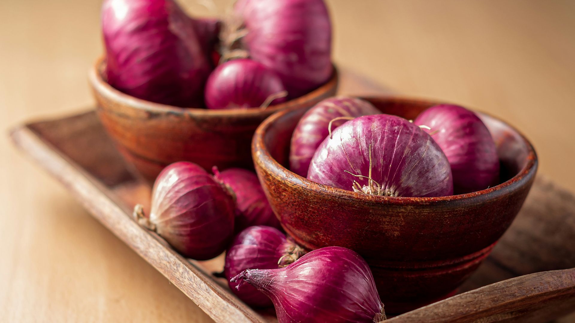 red onion on brown wooden tray