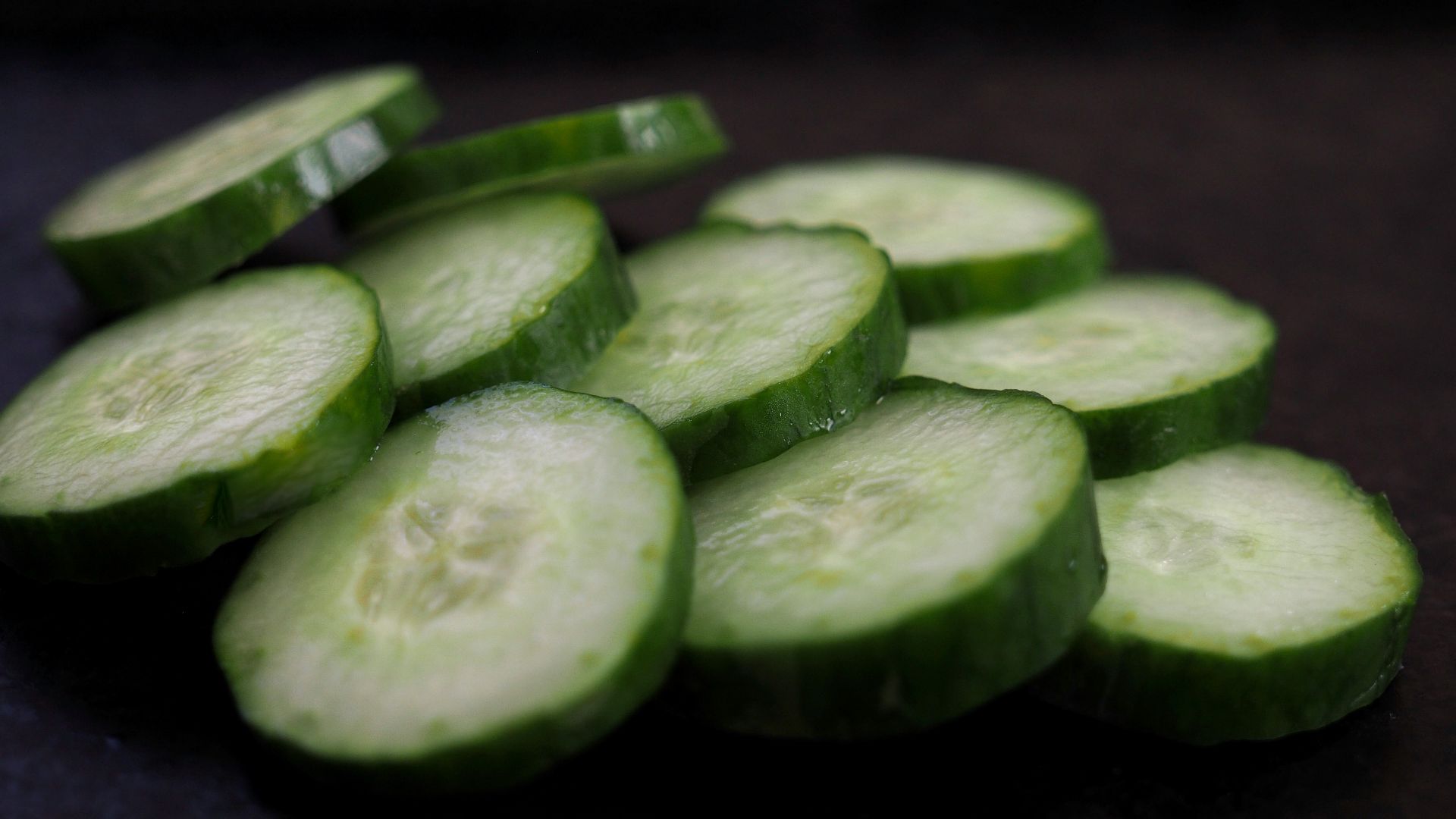 sliced cucumber on brown wooden table