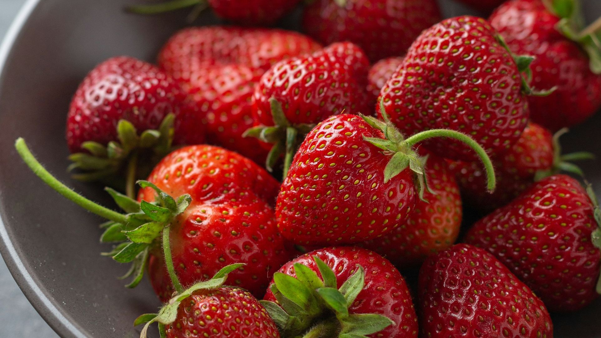 strawberries on white ceramic bowl