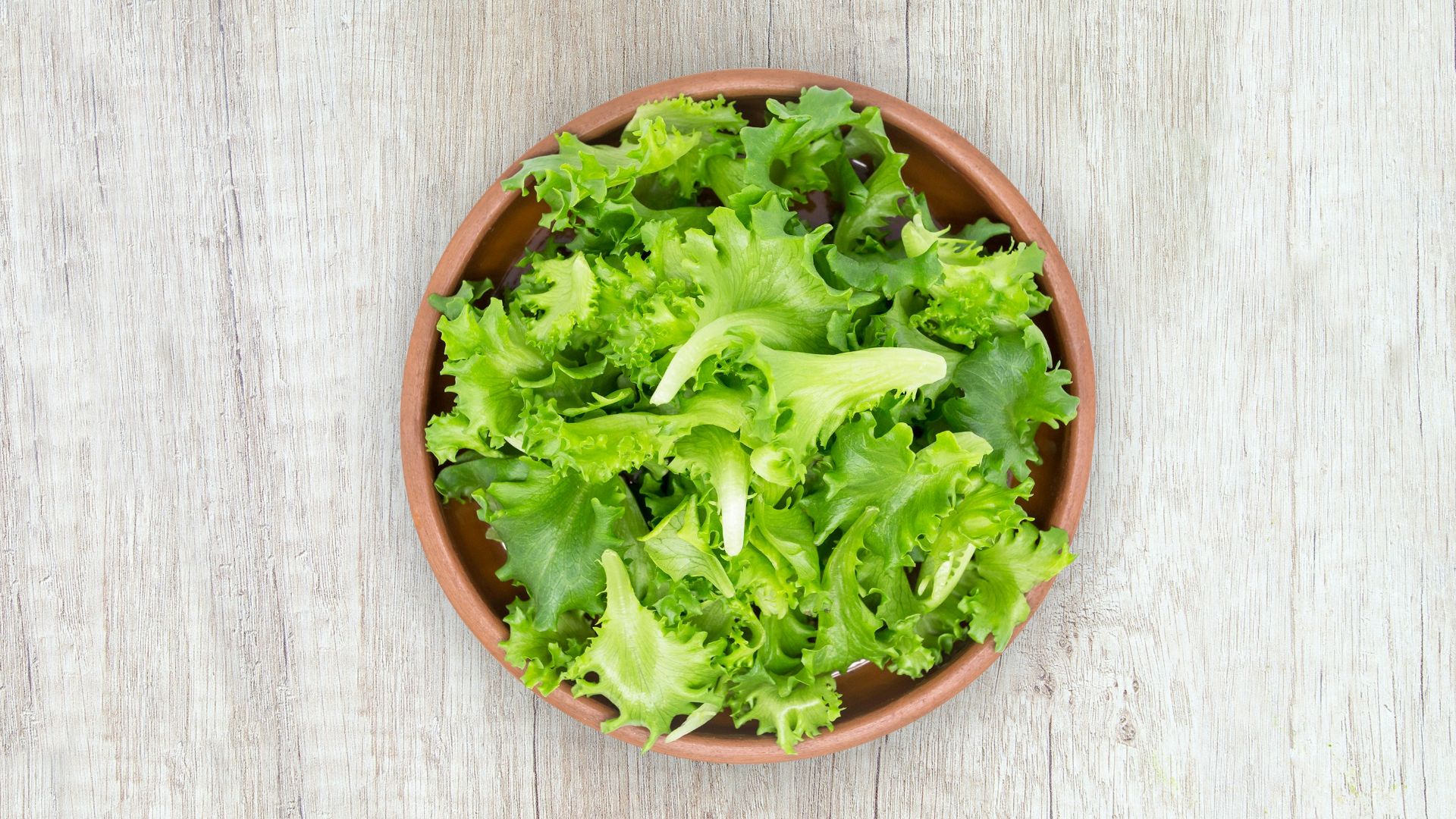 green vegetable on brown round plastic bowl