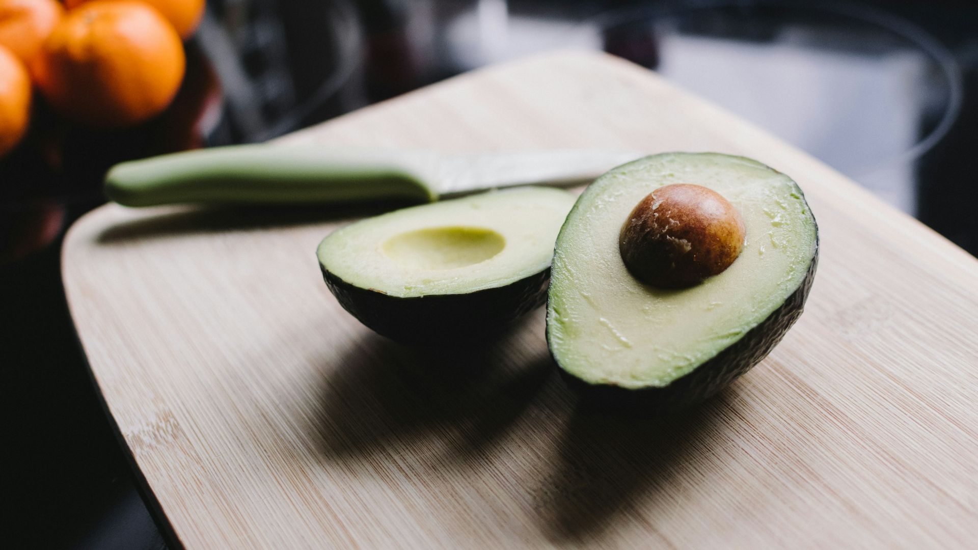 sliced avocado on brown wooden chopping board