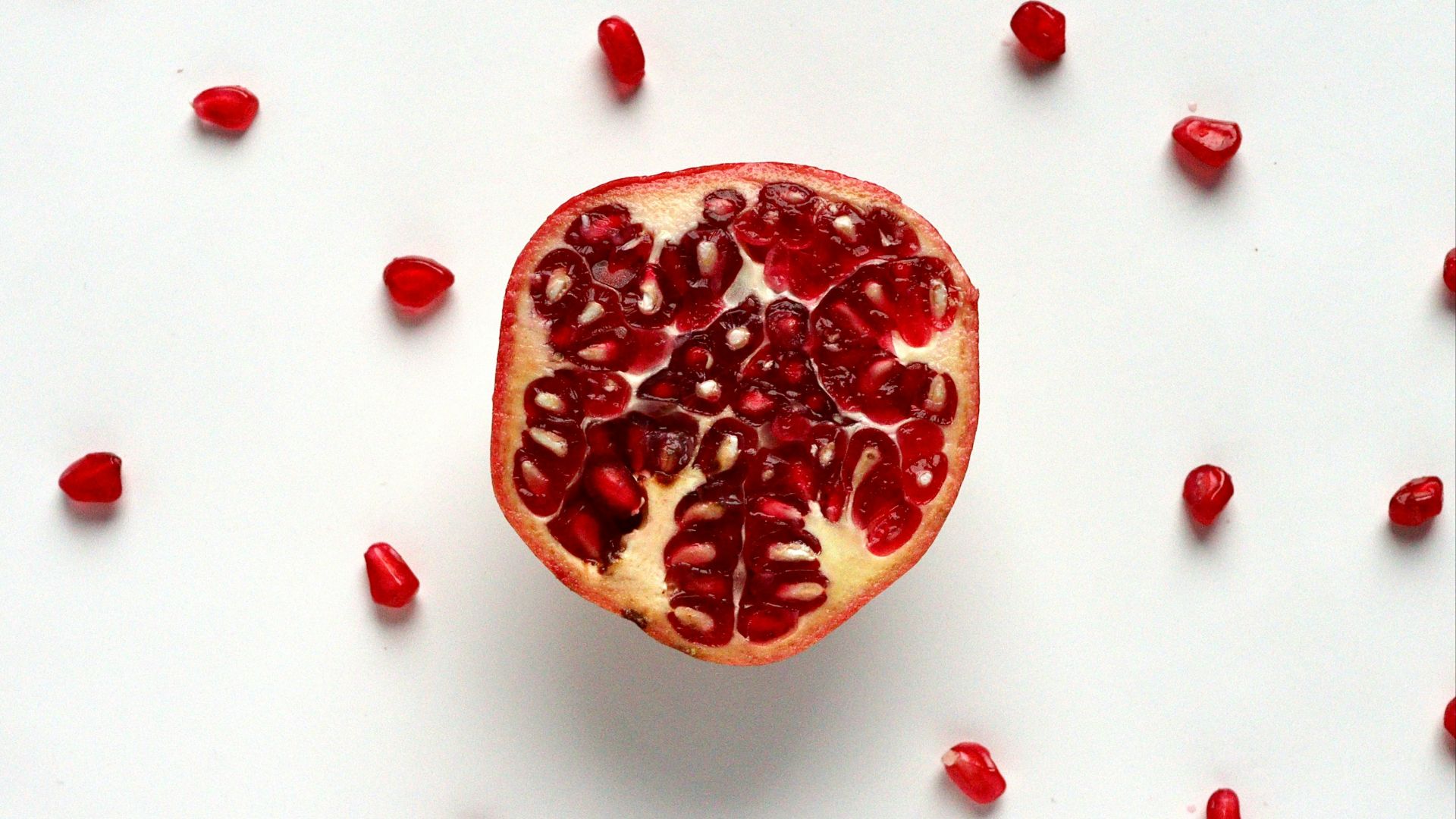 red sliced fruit on white surface