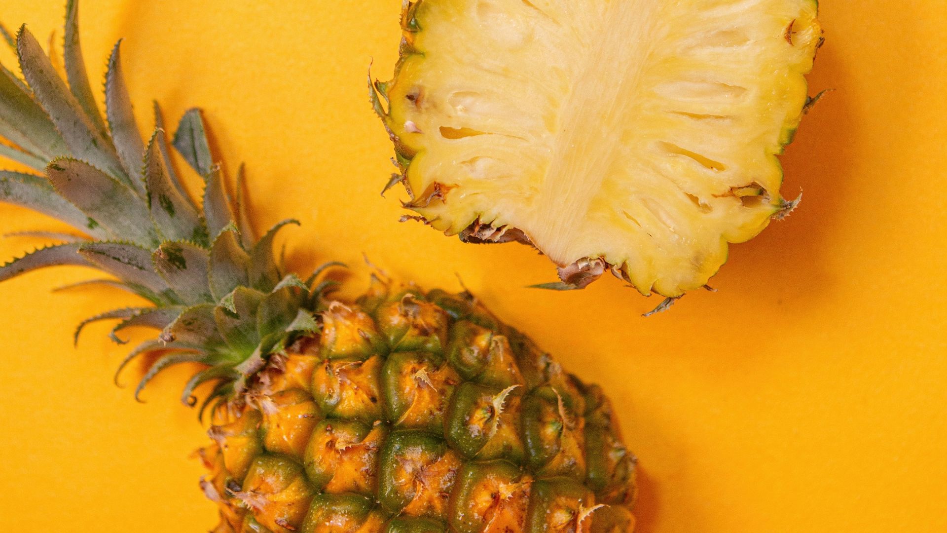 pineapple fruit on yellow surface