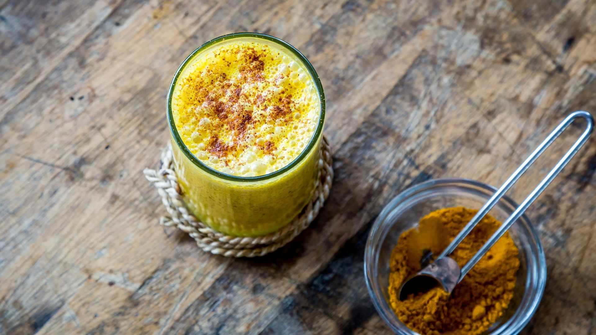 clear drinking glass full of orange liquid