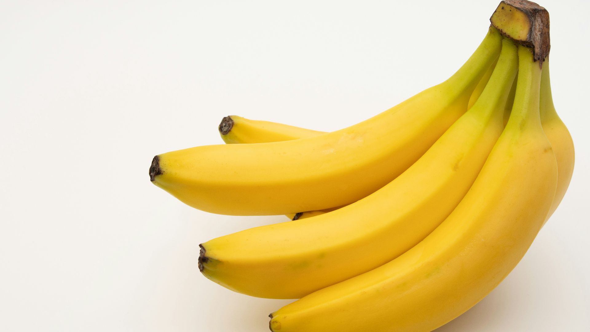 a bunch of bananas sitting on top of a white table