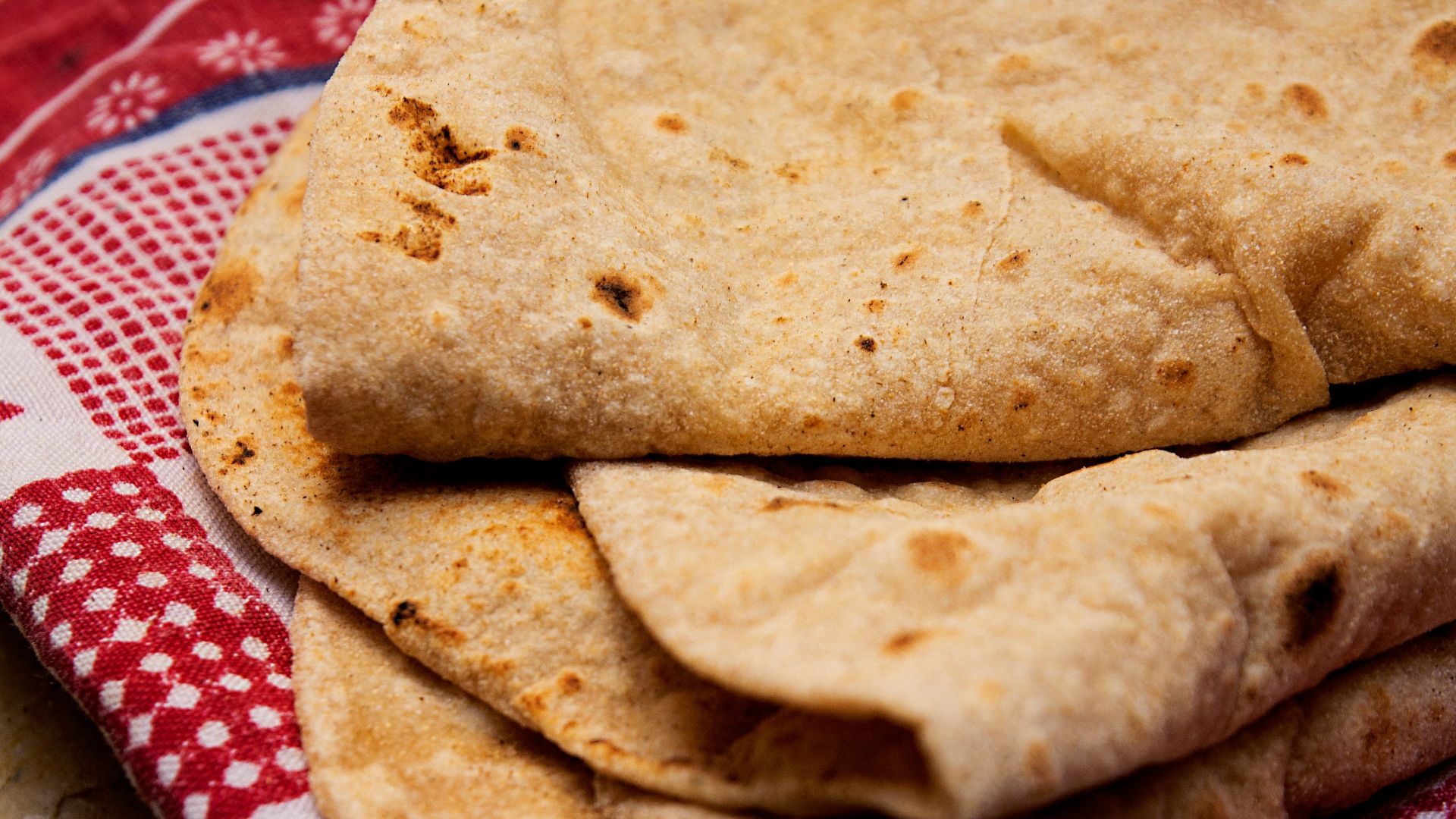 brown bread on red and white textile