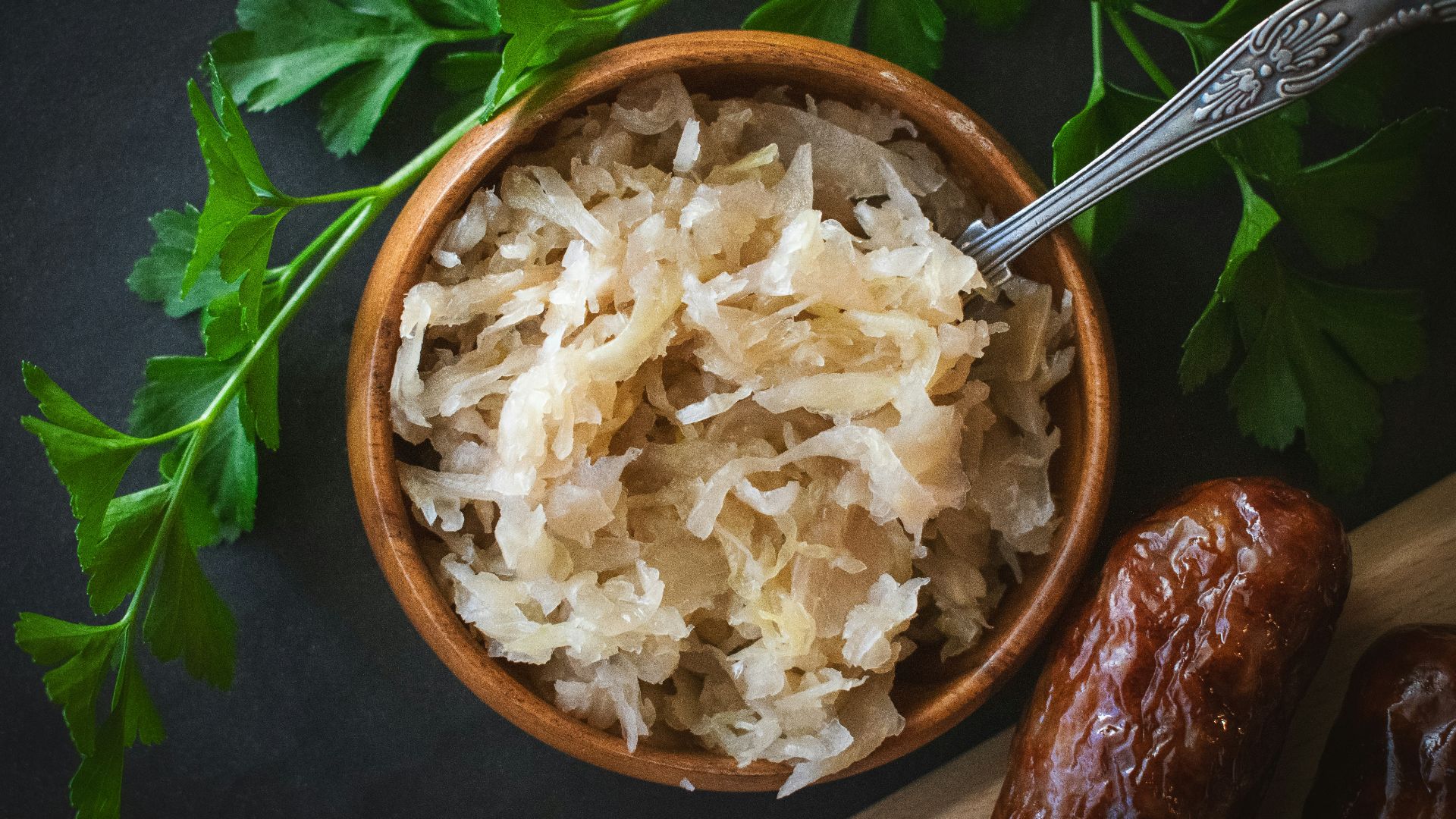 a wooden bowl filled with rice next to a spoon