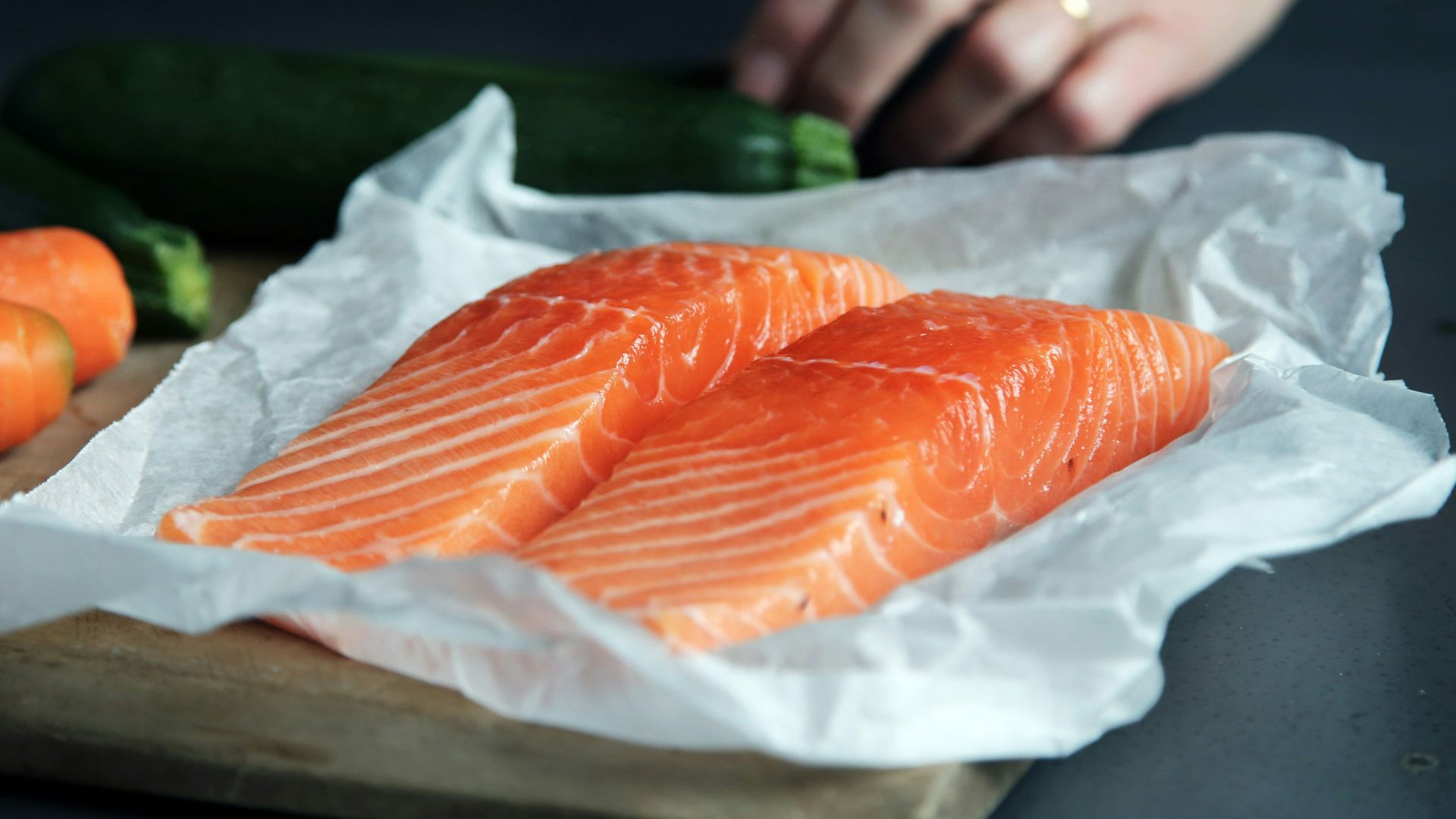 raw fish meat on brown chopping board