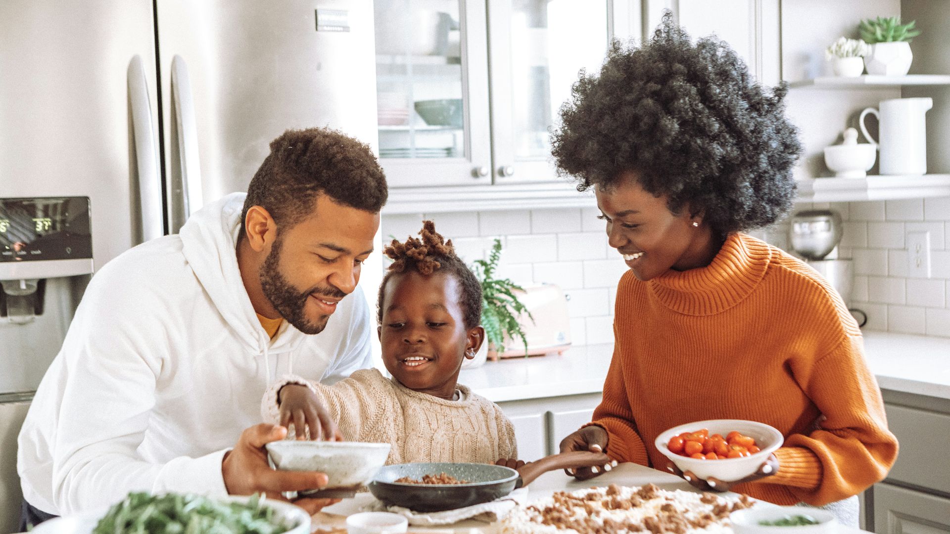 man in white dress shirt sitting beside woman in orange sweater