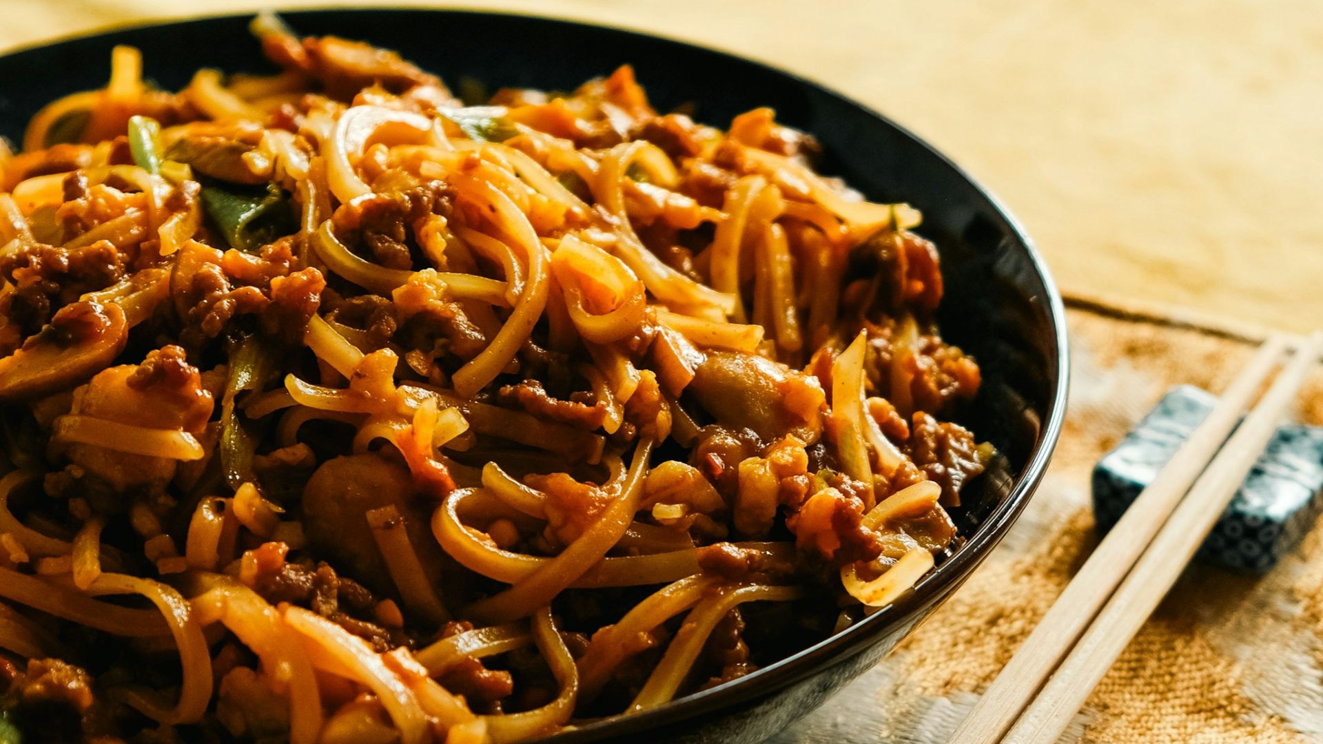 A plate of noodles with meat and vegetables