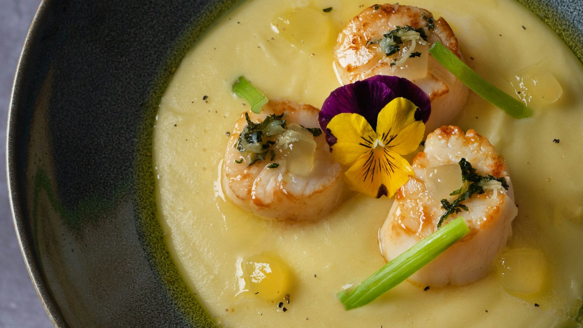 soup in black ceramic bowl