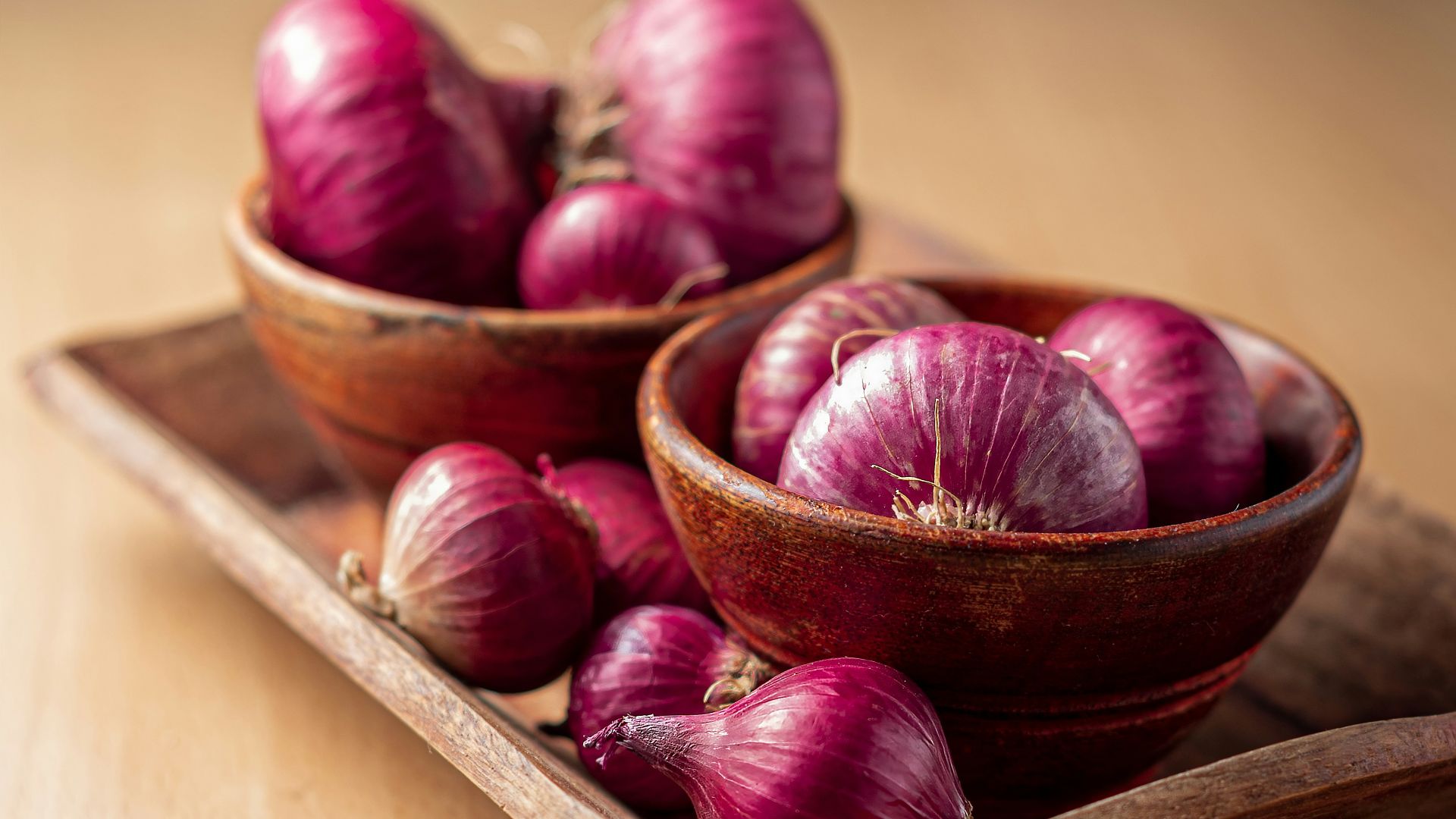 red onion on brown wooden tray