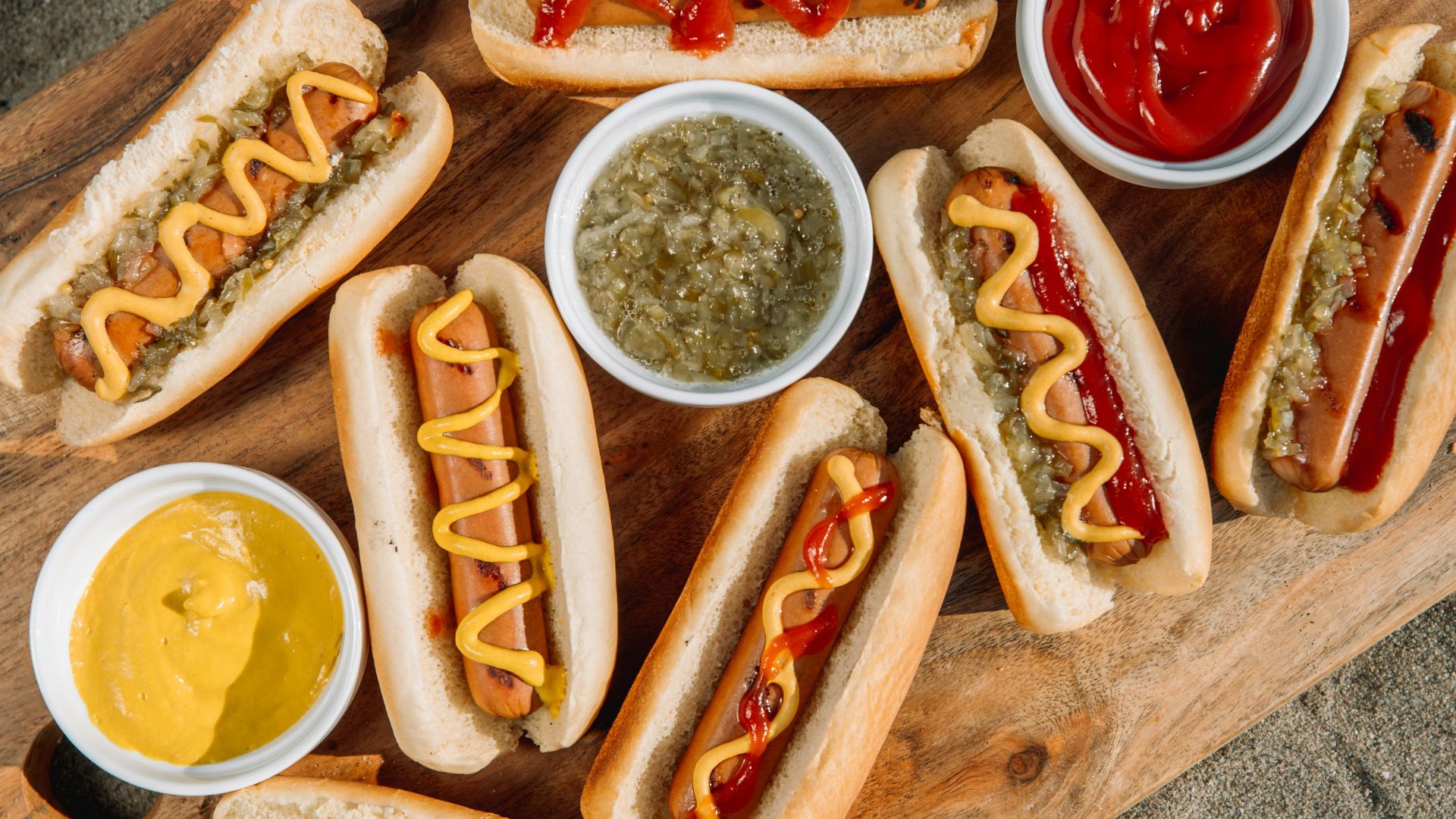 hotdog sandwich with sauce on brown wooden tray