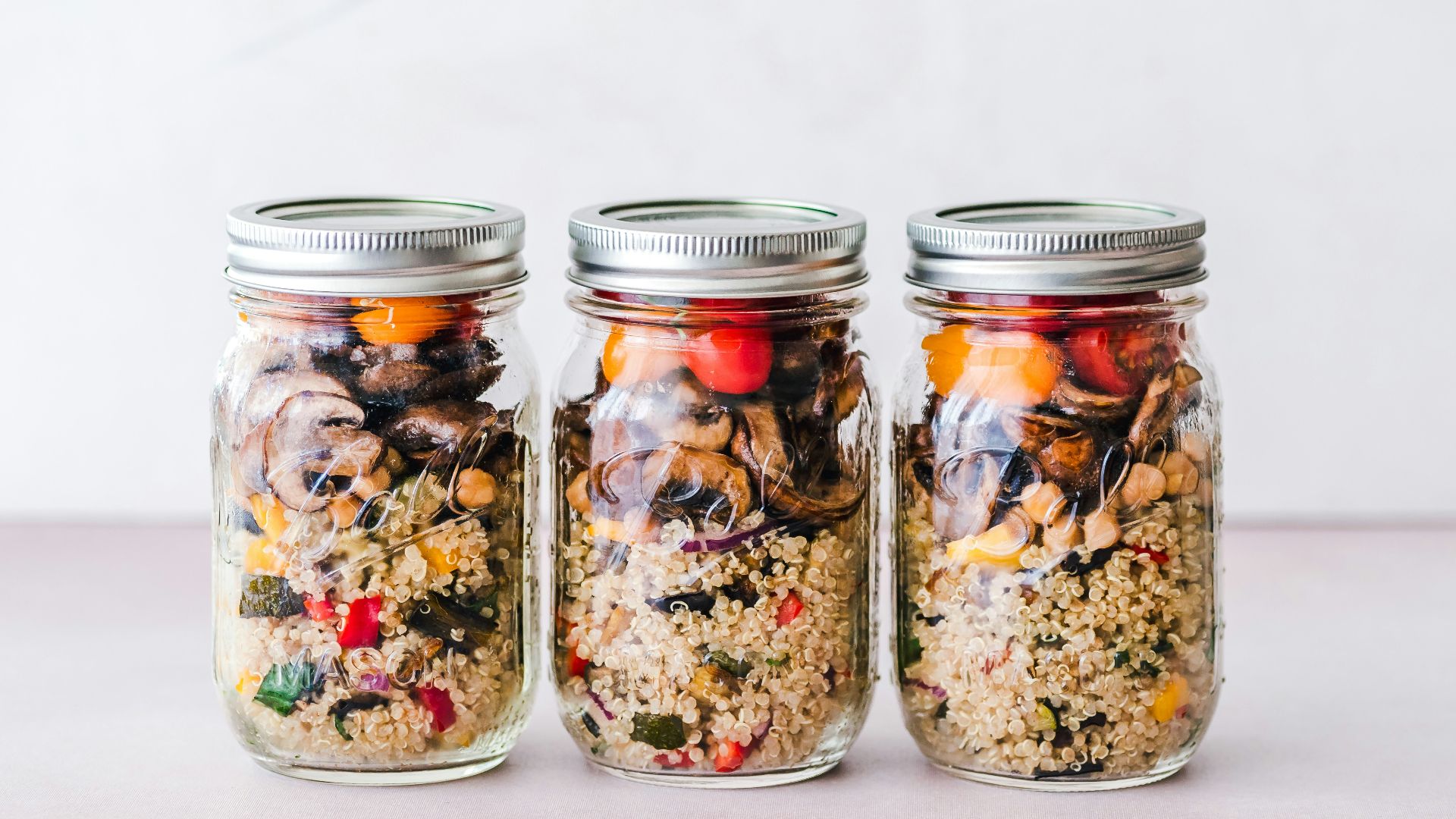 three full clear glass jars with lids