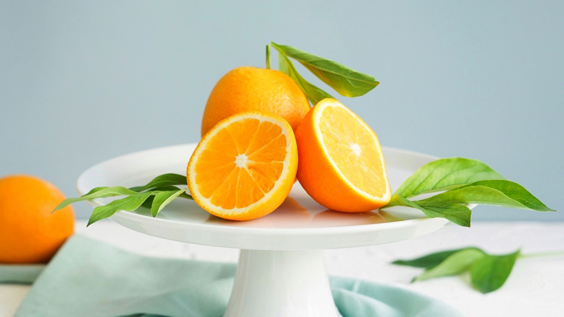 orange fruit in white ceramic plate close-up photography