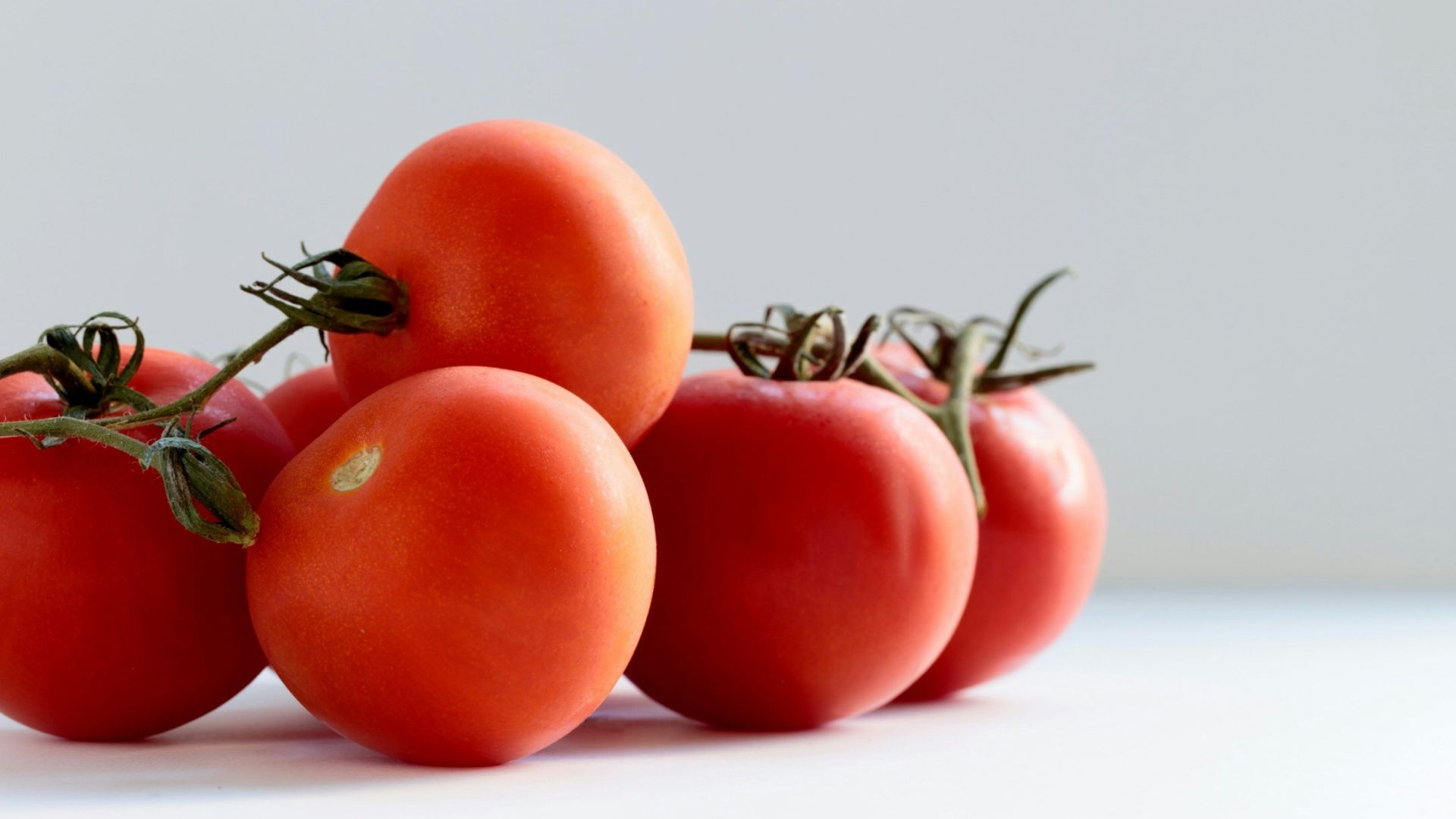 red tomato on white surface